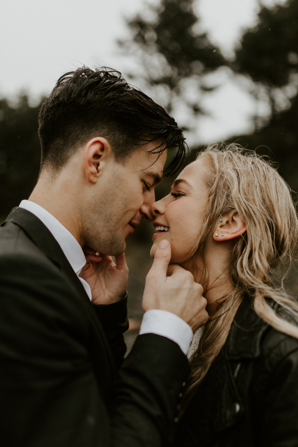 Hannah and Grant move in for a kiss on Cannon Beach, Oregon. Wedding photography in Portland Oregon by Sienna Plus Josh.