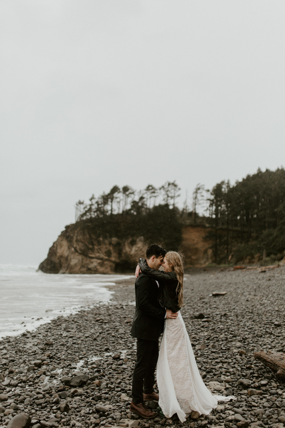 Hannah and Grant hug at Hug Point in Cannon Beach, Oregon. Wedding photography in Portland Oregon by Sienna Plus Josh.