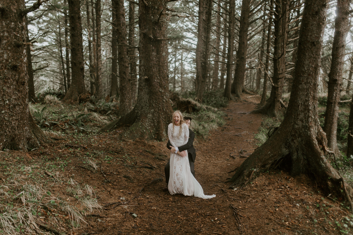 Grant prepares to lift Hannah in the woods of Cannon Beach, Oregon during their Oregon coast elopement. Wedding photography in Portland Oregon by Sienna Plus Josh.