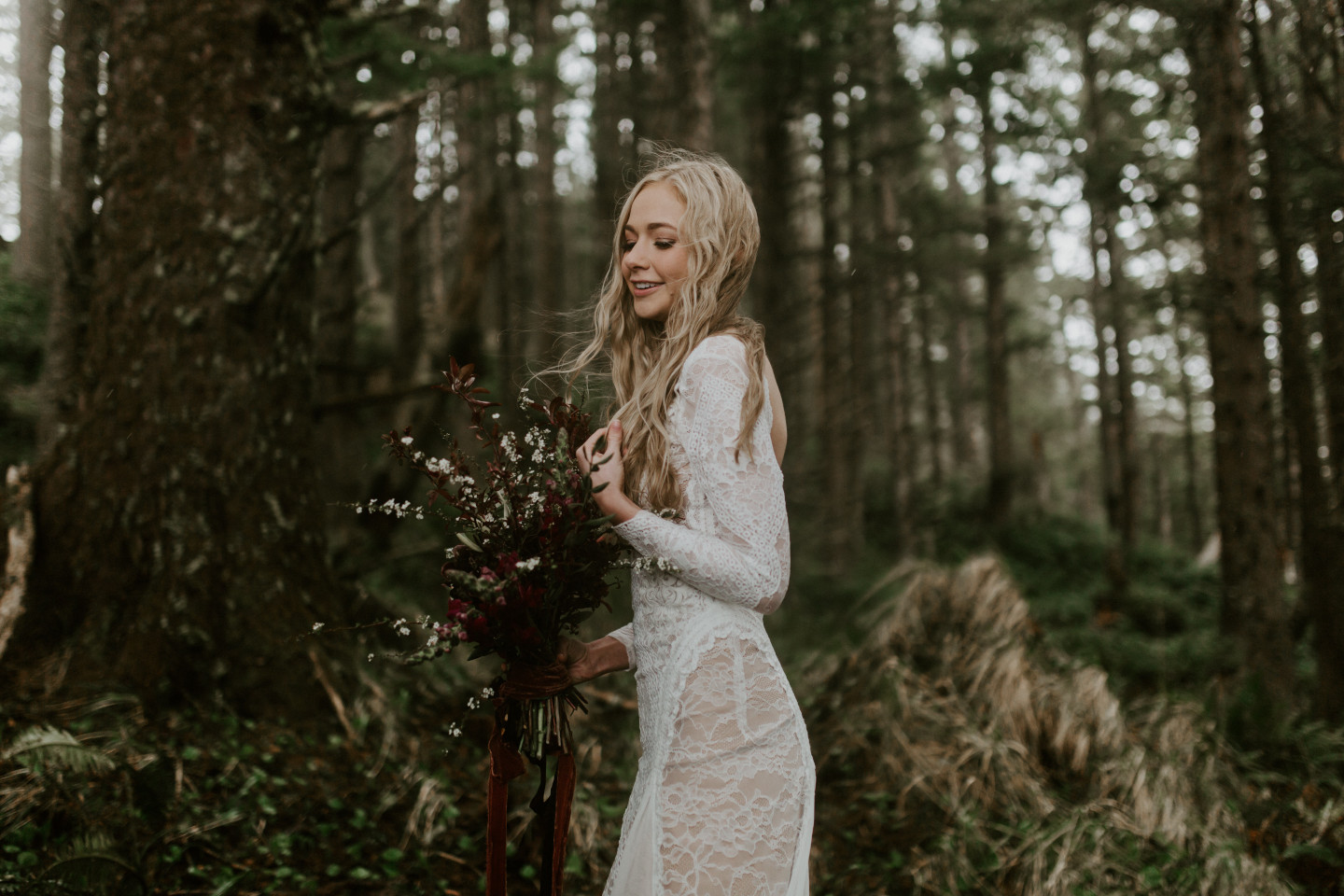 Hannah stands alone in the woods of Cannon Beach, Oregon during her Oregon coast elopement. Wedding photography in Portland Oregon by Sienna Plus Josh.