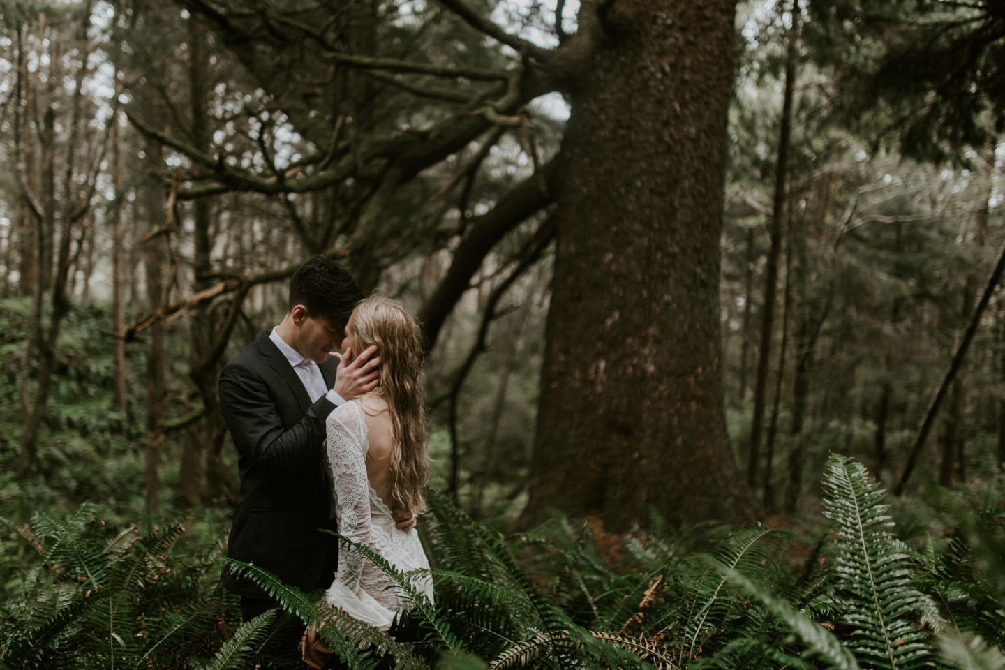 Hannah and Grant stand in the ferns in Cannon Beach, Oregon. Wedding photography in Portland Oregon by Sienna Plus Josh.