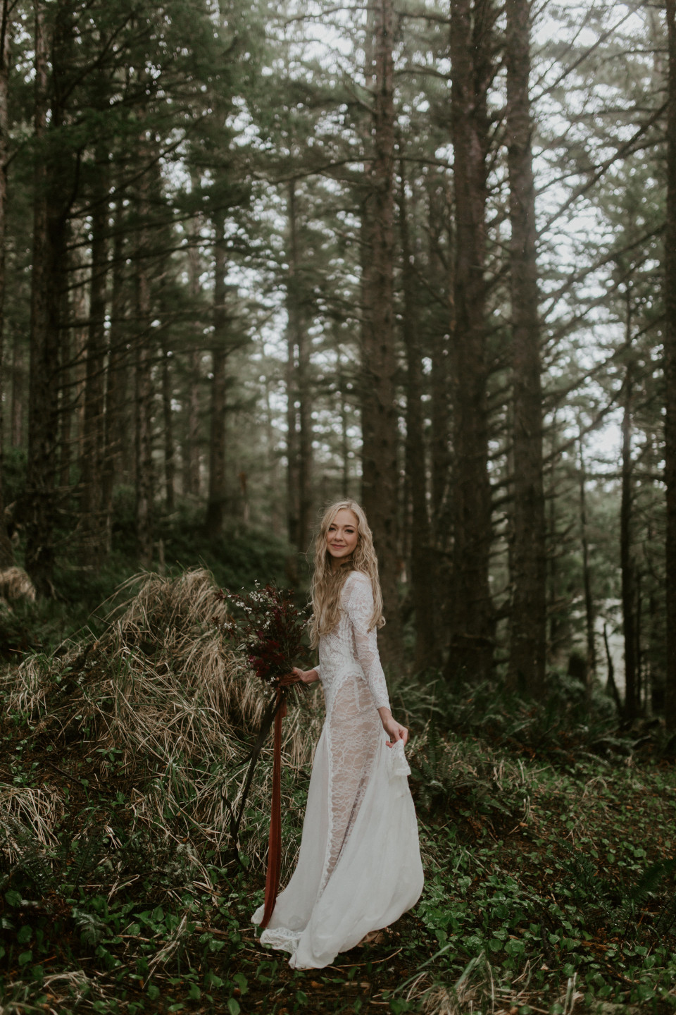 Hannah smiles for her picture among the trees at Cannon Beach, Oregon for her Oregon coast elopement. Wedding photography in Portland Oregon by Sienna Plus Josh.