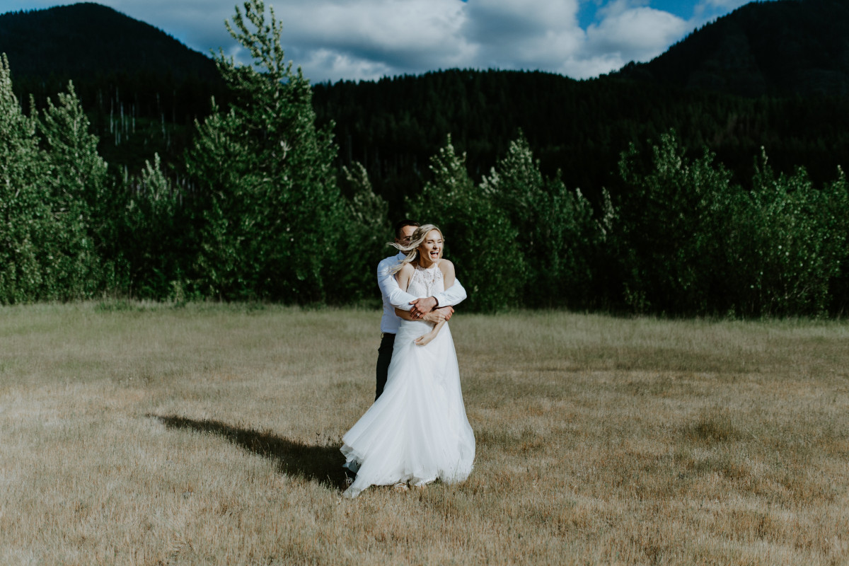 Trevor holds Harper from behind at the Columbia Gorge, Oregon. Elopement photography in Portland Oregon by Sienna Plus Josh.