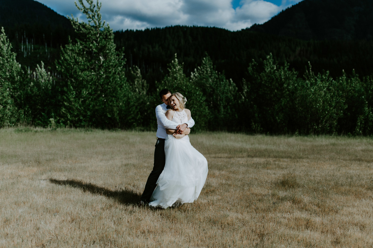 Harper laughs as Trevor holds her at Cascade Locks at the Columbia Gorge, Oregon. Elopement photography in Portland Oregon by Sienna Plus Josh.