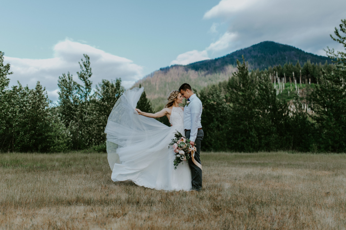 Harper throws her dress train into the air at Cascade Locks at the Columbia Gorge, Oregon. Elopement photography in Portland Oregon by Sienna Plus Josh.