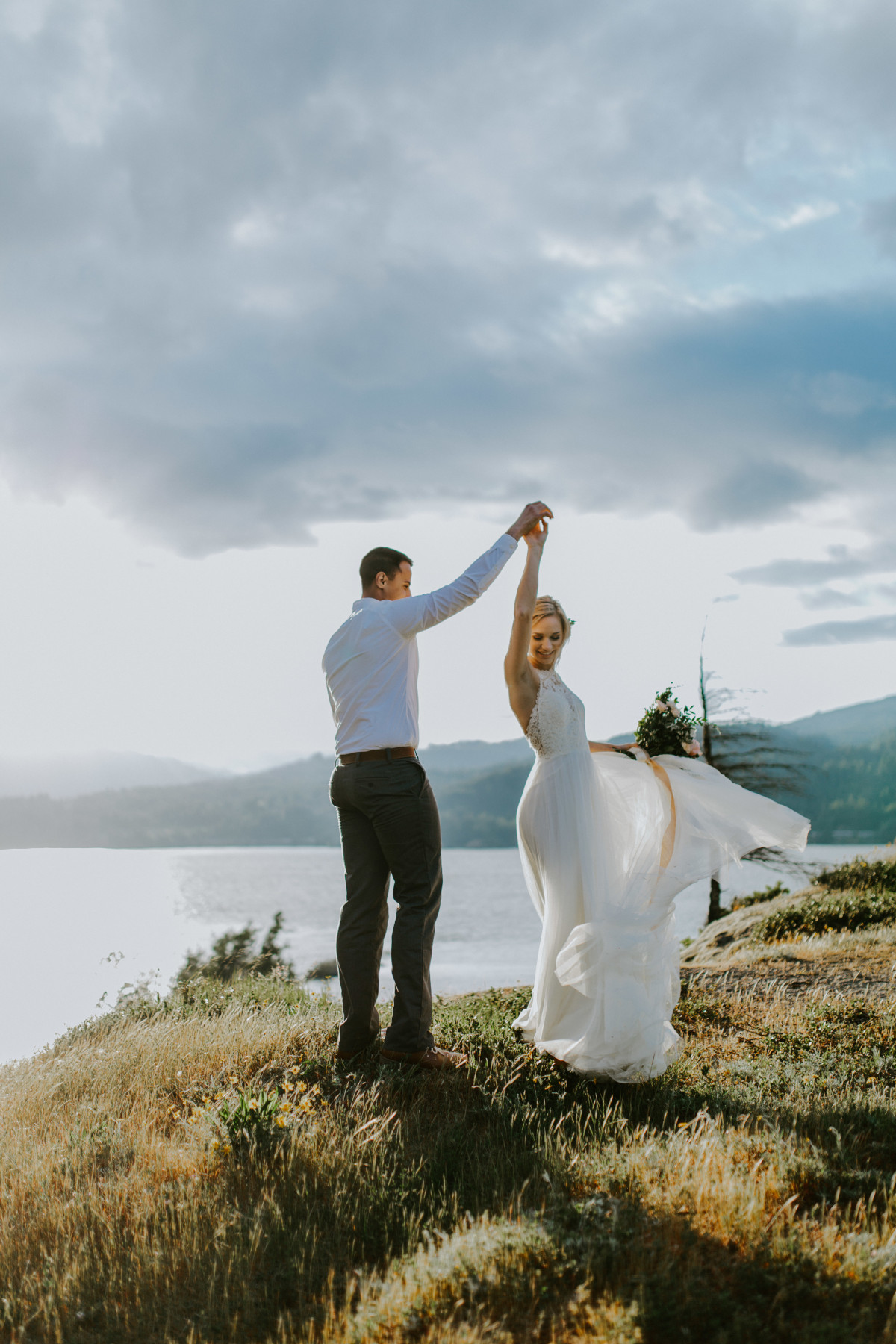 Harper and Trevor dance near the river at Cascade Locks at the Columbia Gorge, Oregon. Elopement photography in Portland Oregon by Sienna Plus Josh.