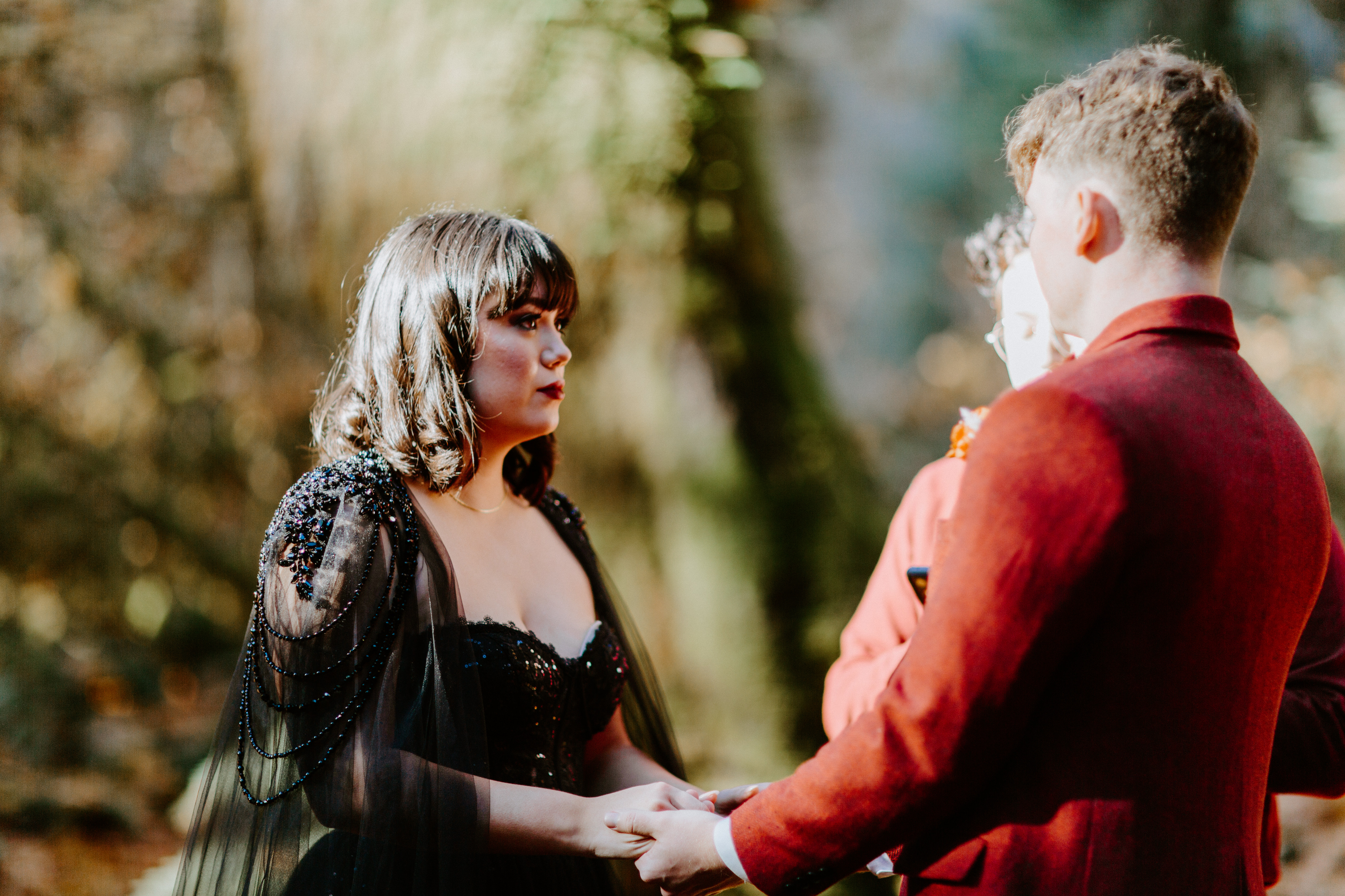 Brett and Bethany hold hands during their elopement in the Hoh Rainforest, Washington.