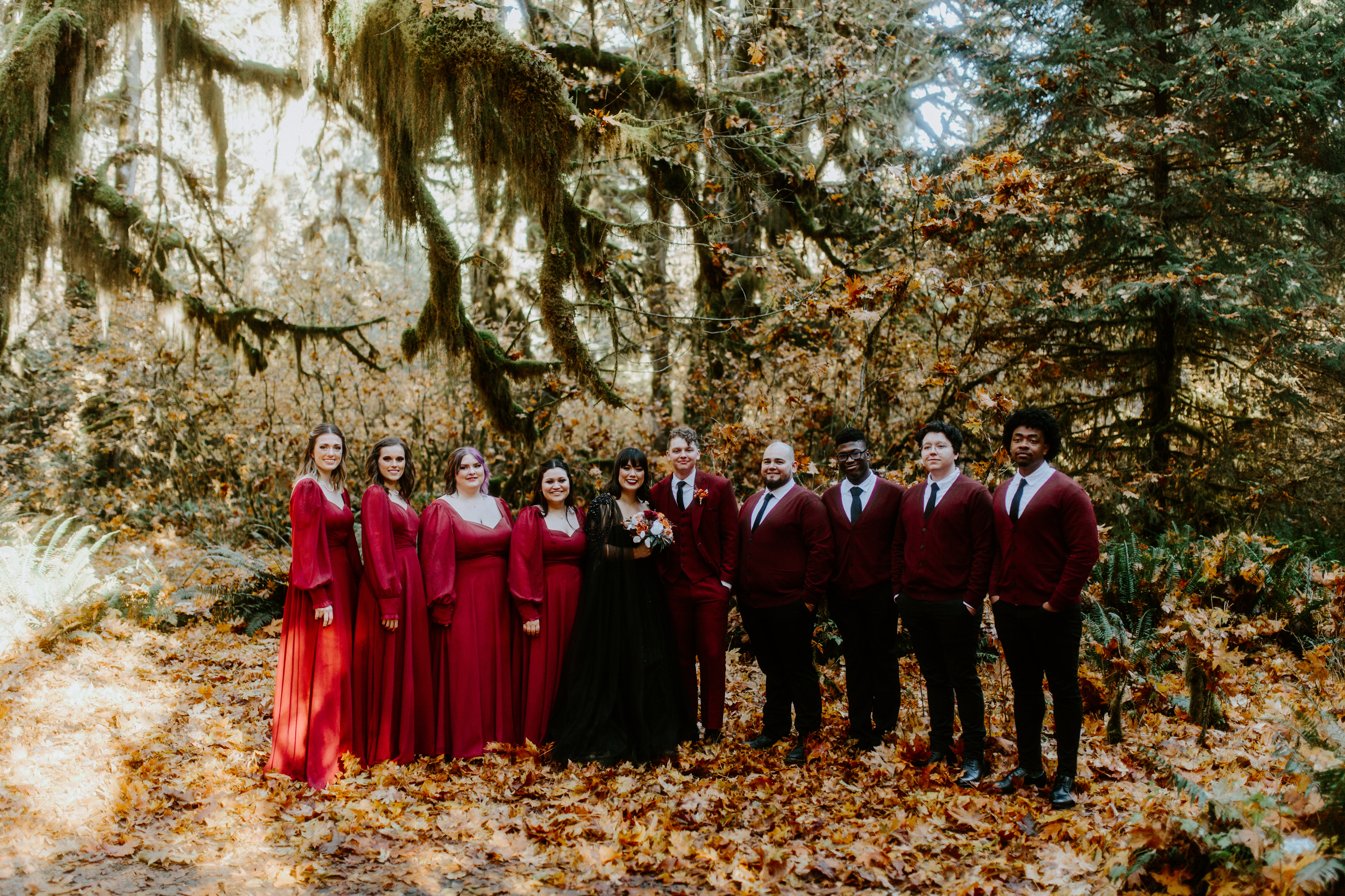 Bethany and Brett stand with their bridesmaids and groomsen during their elopement in the Hoh Rainforest, Washington.