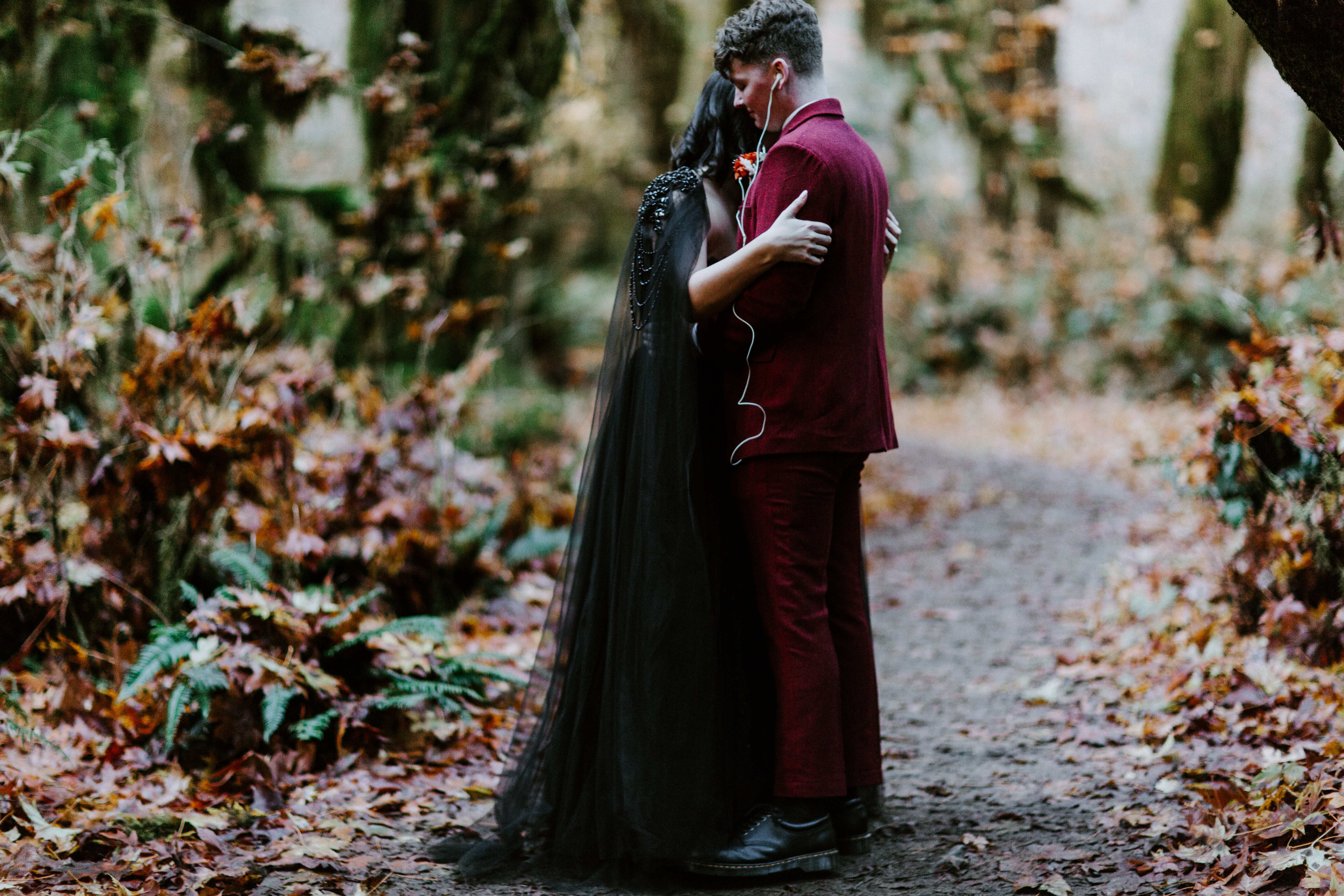 Brett and Bethany share their first dance after their elopement in Hoh Rainforest sharing earbuds.