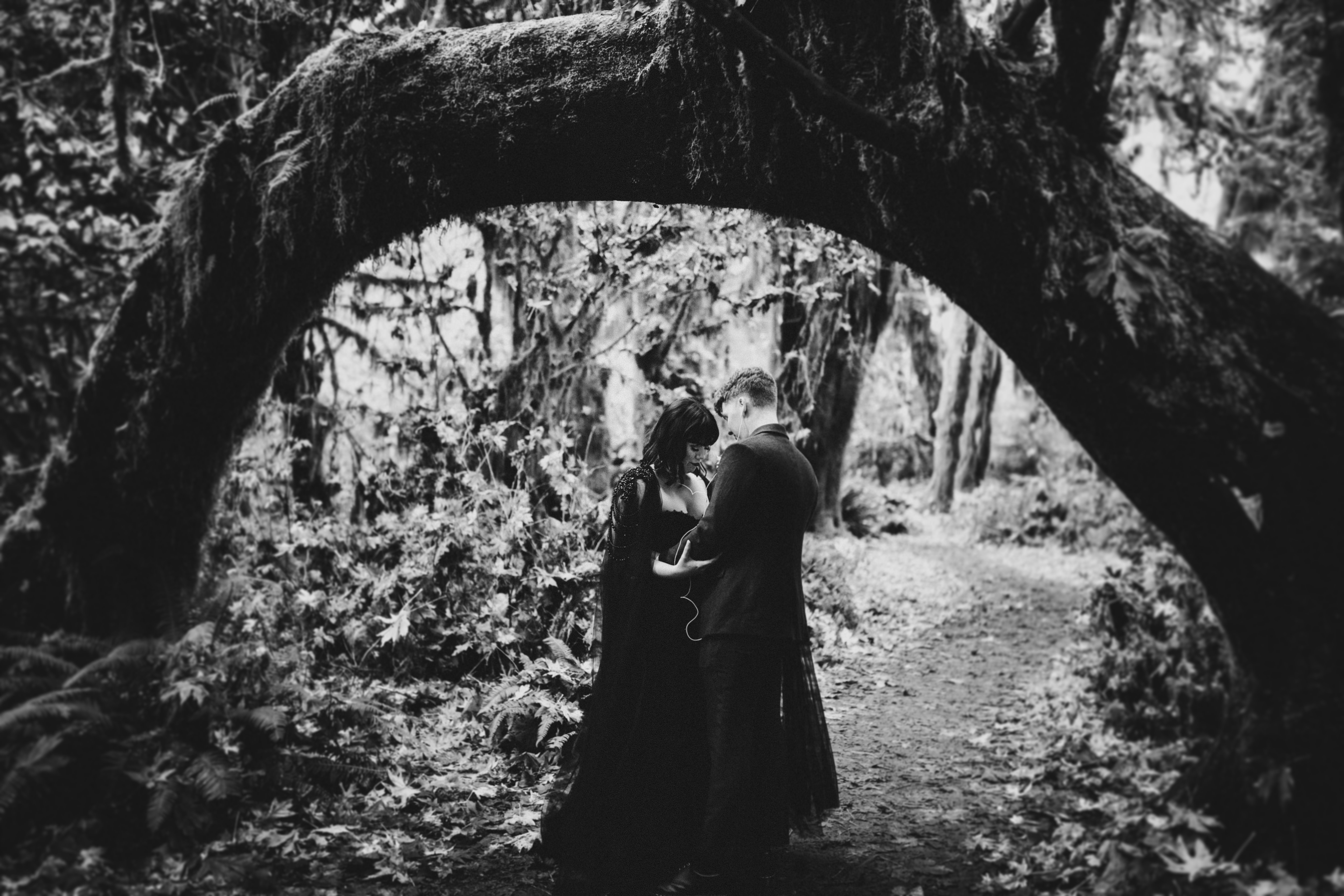 Bethany and Brett share earbuds as the dance in the forest of the Hoh Rainforest after their elopement.