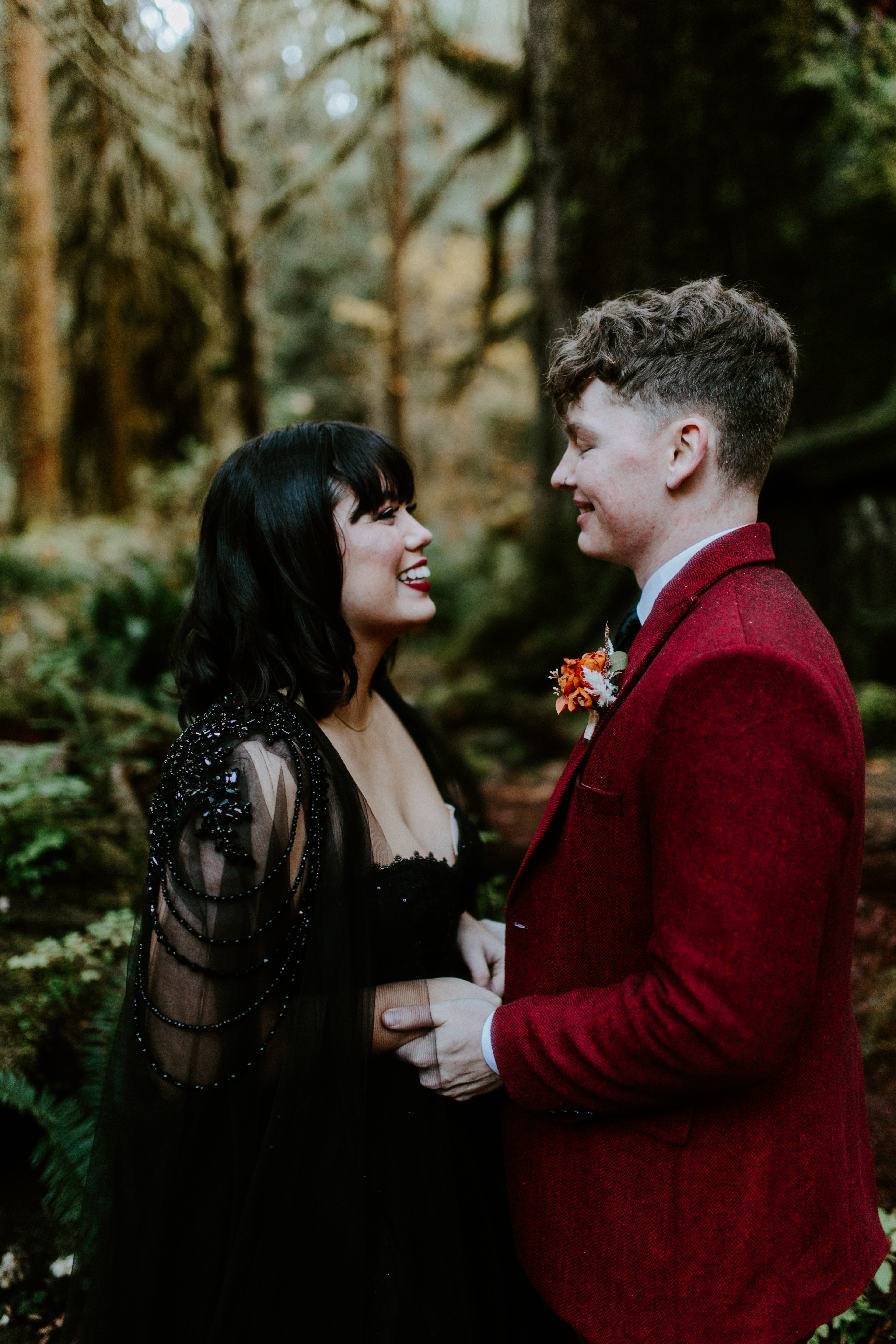 Bethany and Brett hold hands in Hoh Rainforest after their elopement.