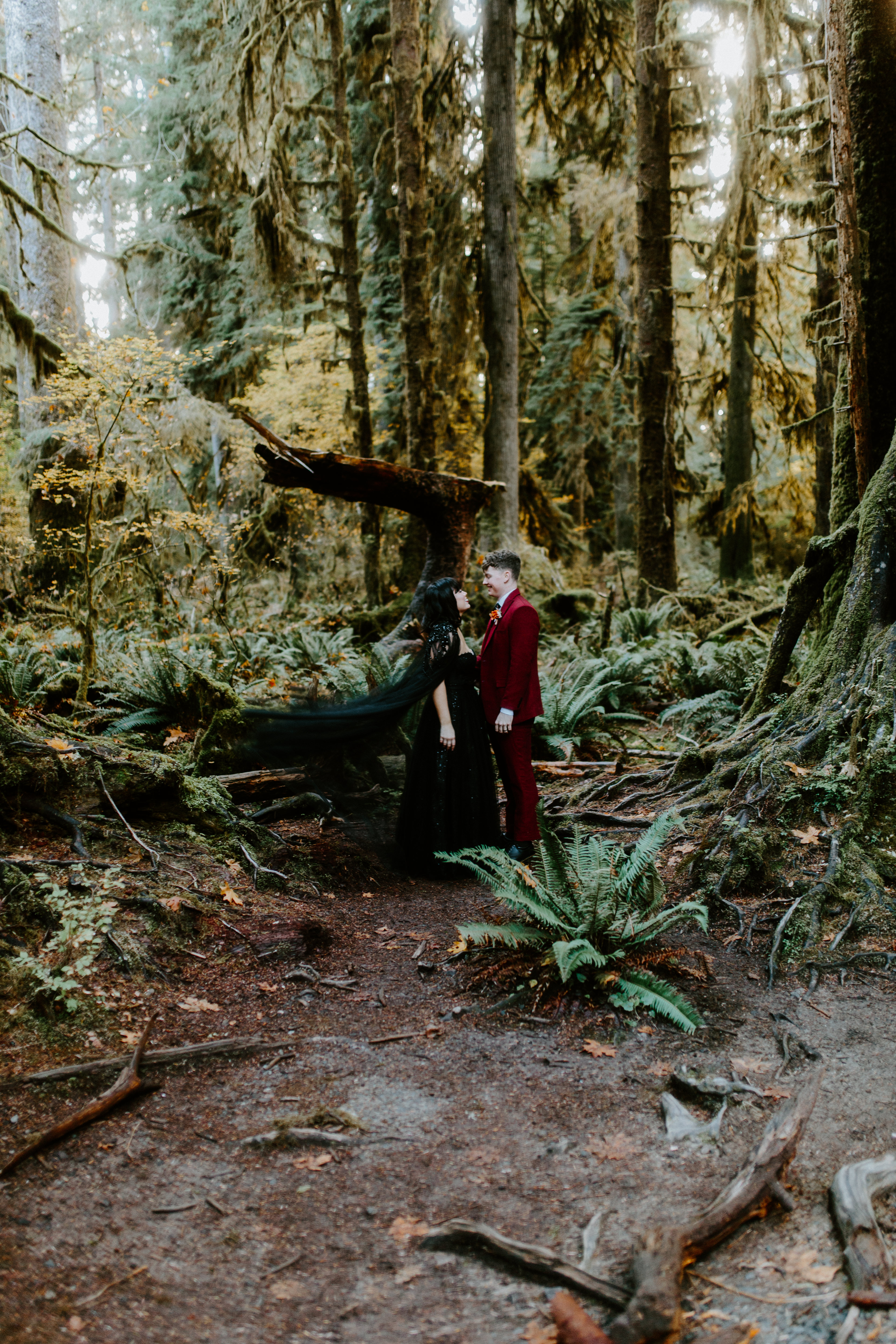 Brett and Bethany smile together in the Hoh Rainforest after their elopement.