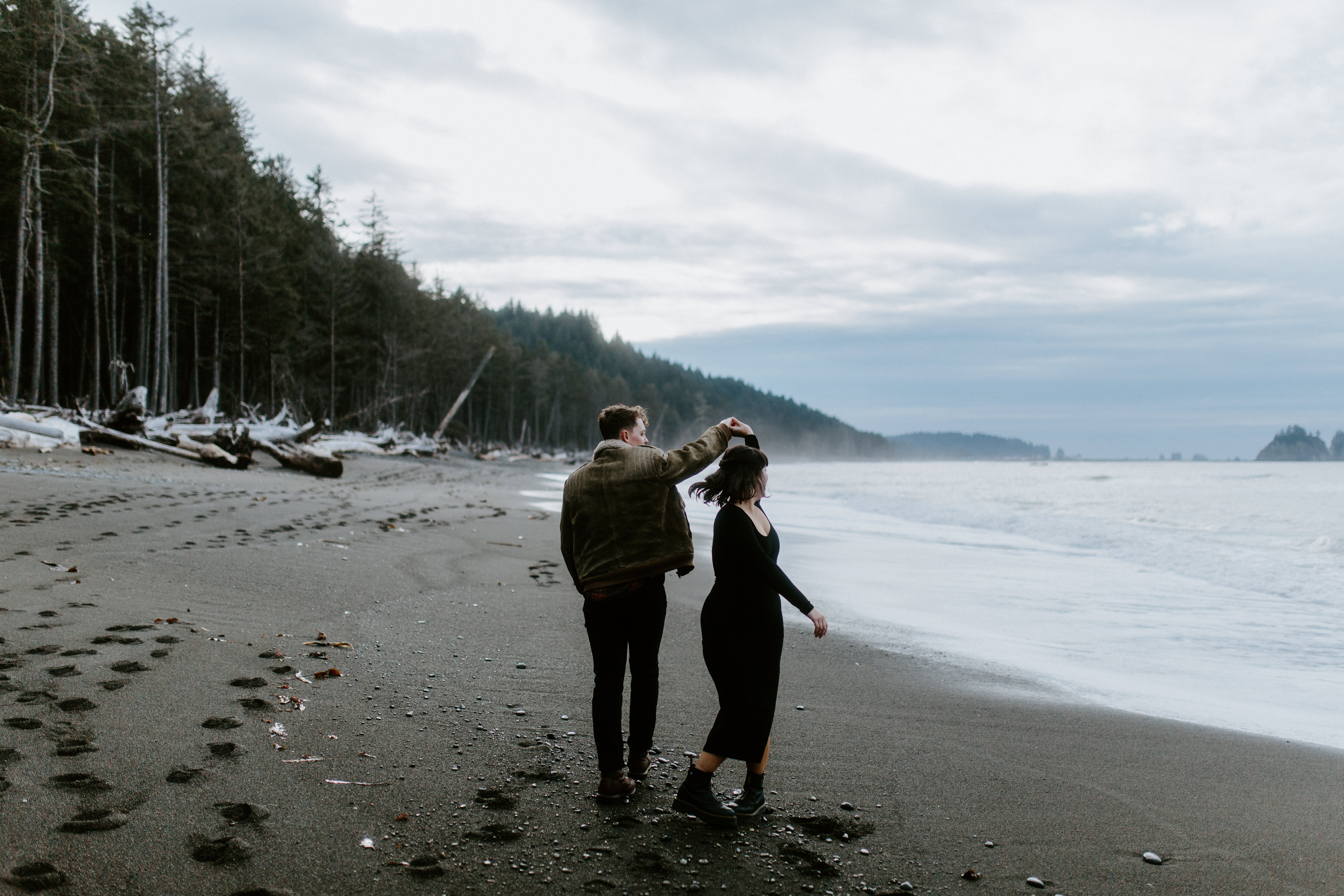 Brett twirls Bethany on the beach at Rialto Beach, Washington.