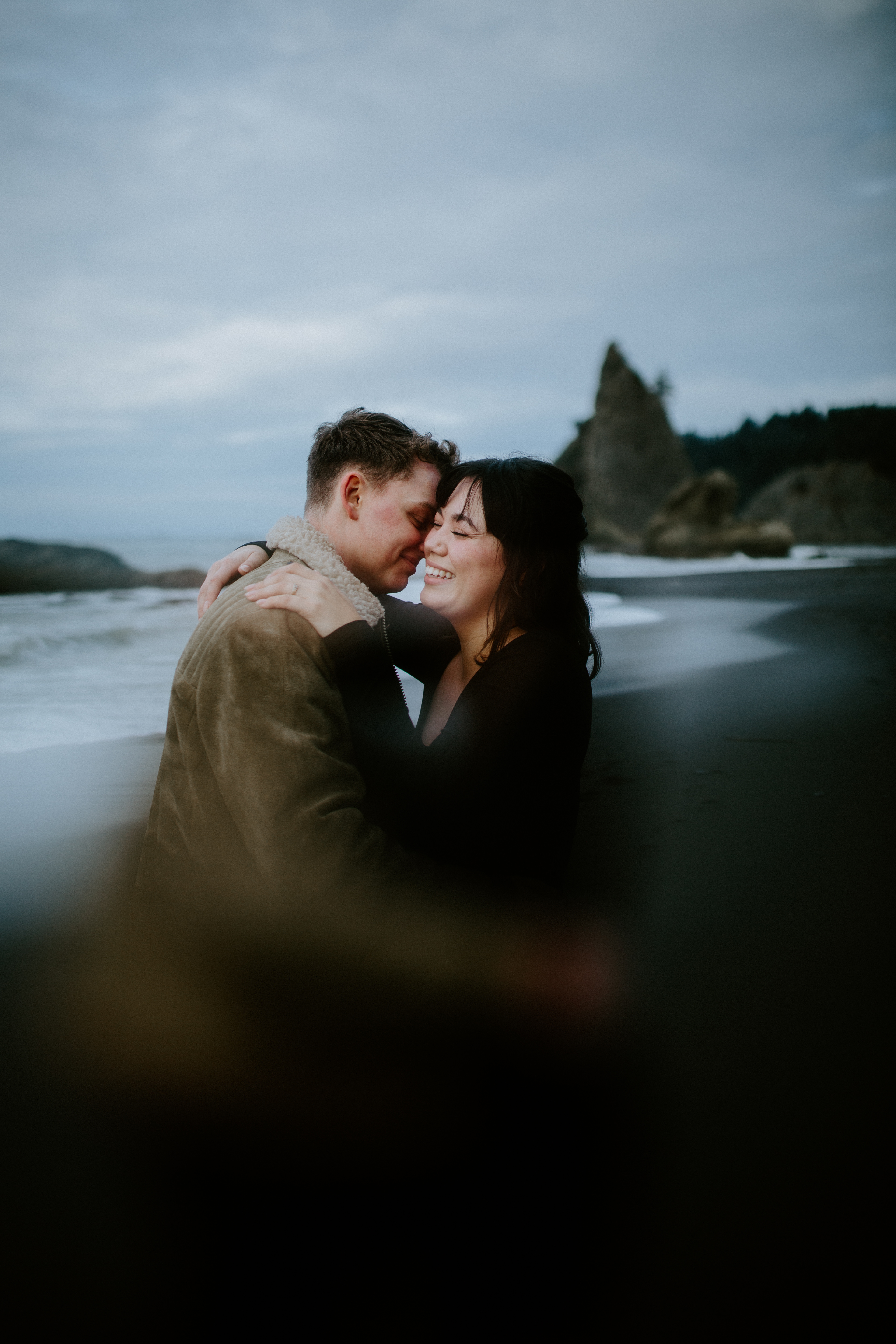 Bethany and Brett go in for a hug at Rialto Beach, Washington.