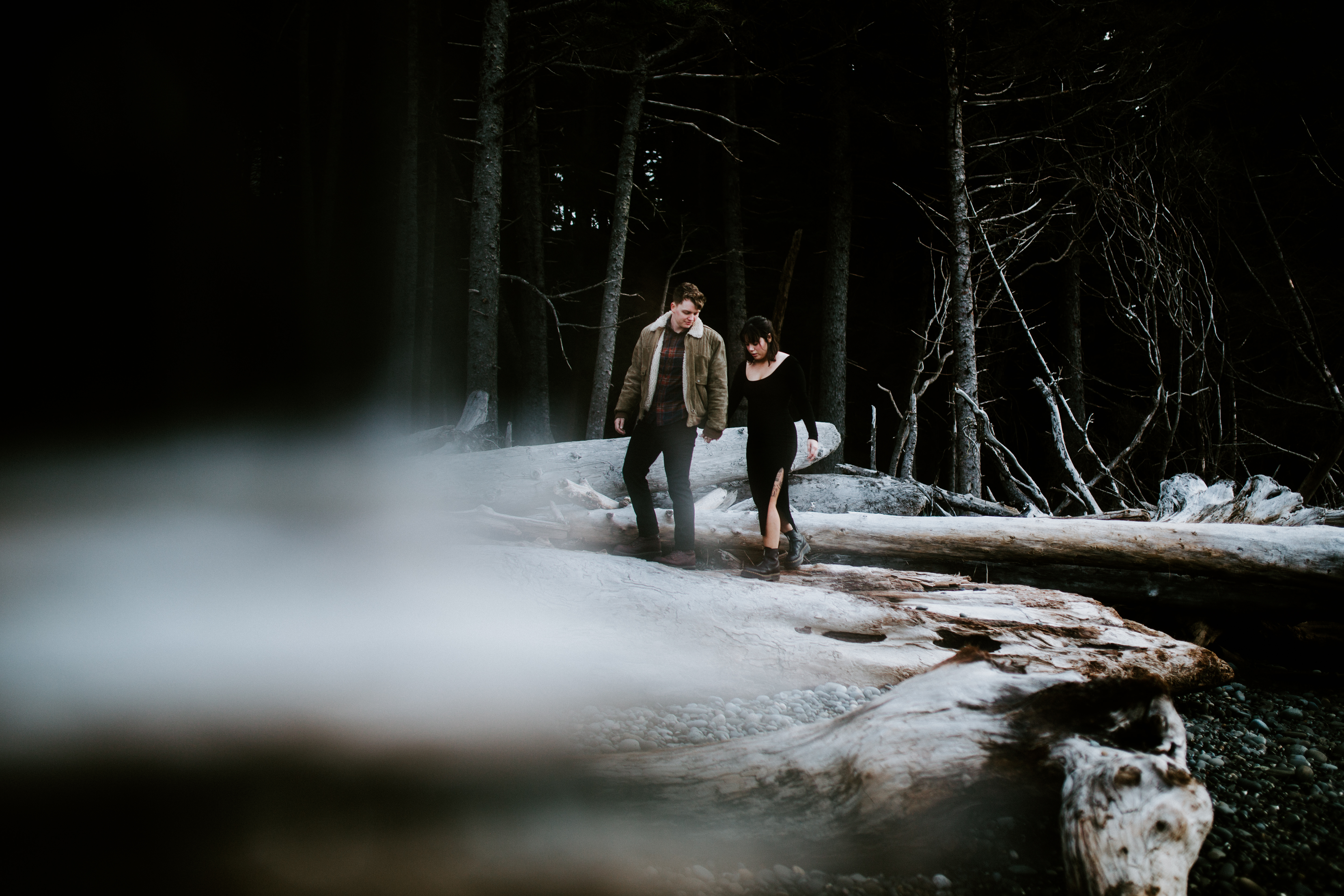 Brett and Bethany walk along the driftwood at Rialto Beach, Washington.