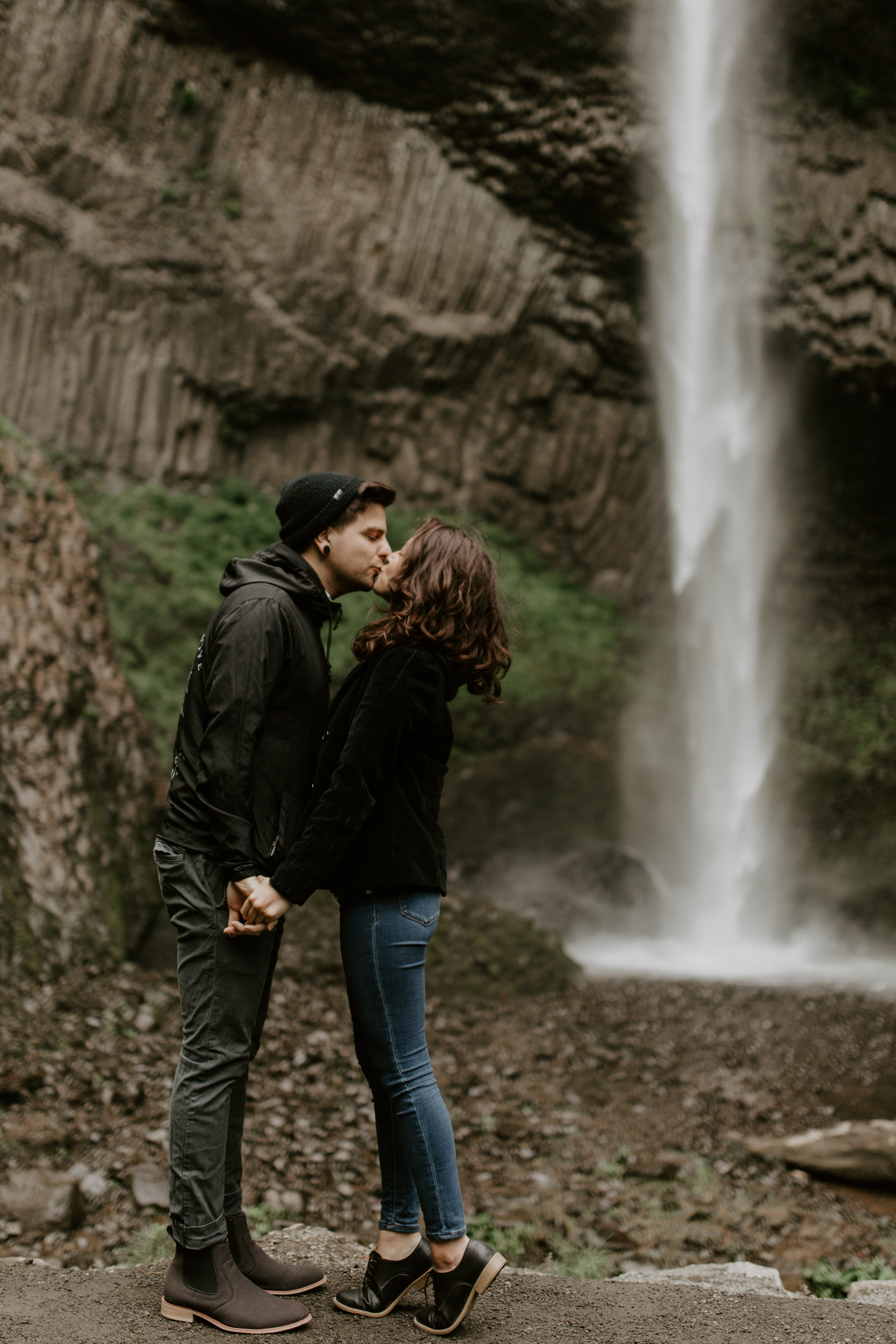 Jasmine and Chris kiss at Latourell Falls, Oregon. Adventure photography in Portland Oregon by Sienna Plus Josh.