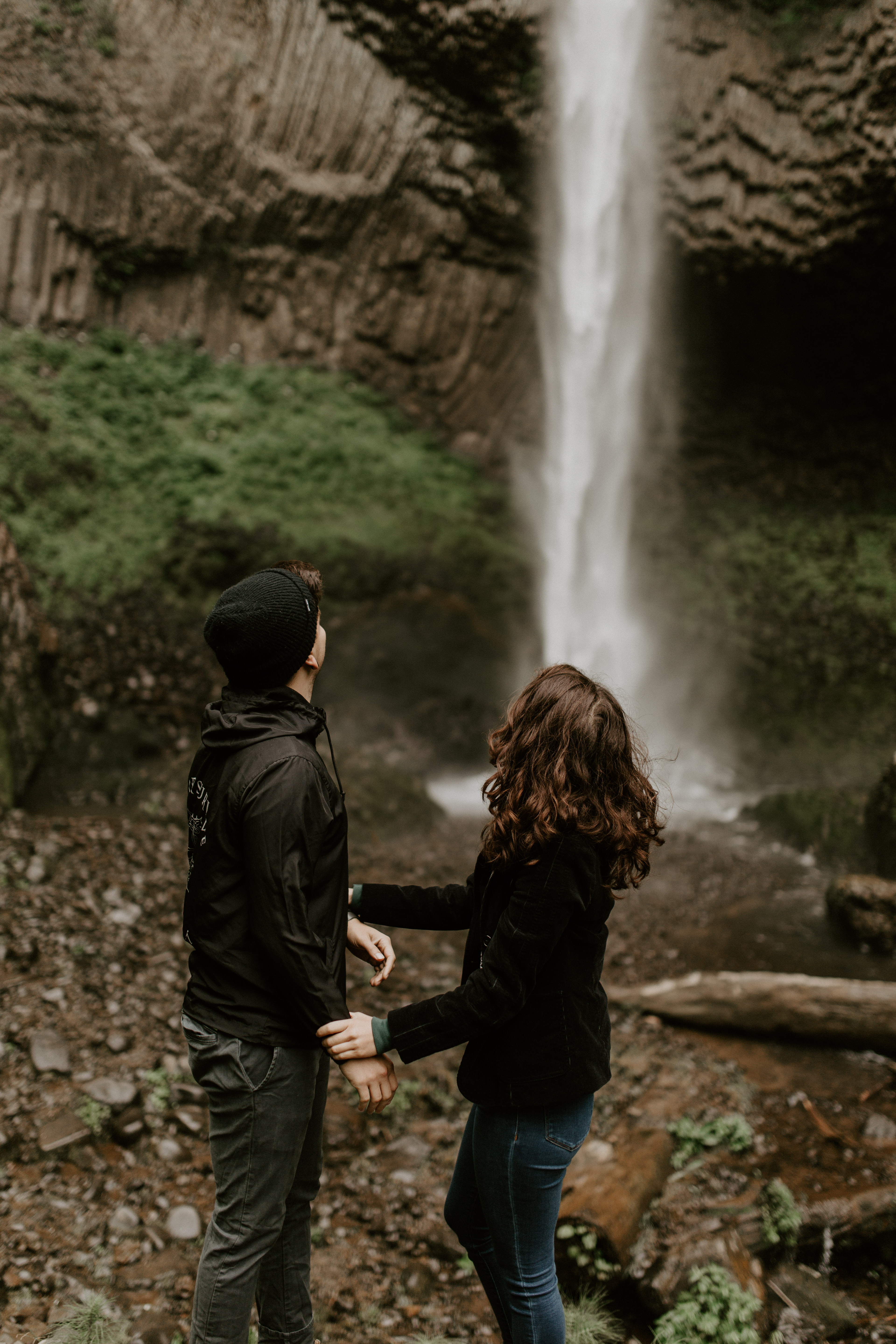 Jasmine and Chris stand at the lower falls at Latourell Falls in Oregon. Adventure photography in Portland Oregon by Sienna Plus Josh.