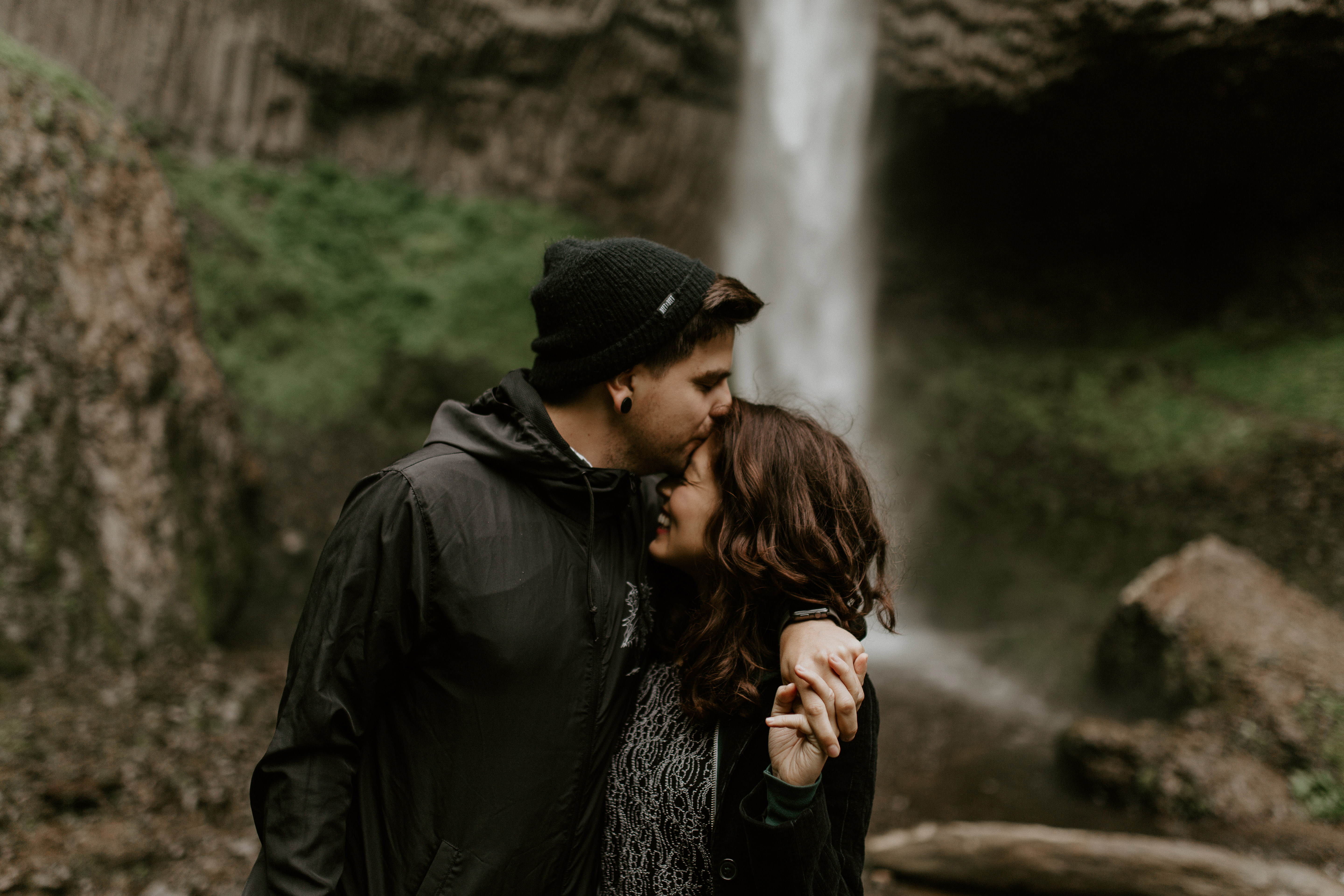 Chris kisses Jasmine on the forehead at Latourell Falls, Oregon. Adventure photography in Portland Oregon by Sienna Plus Josh.