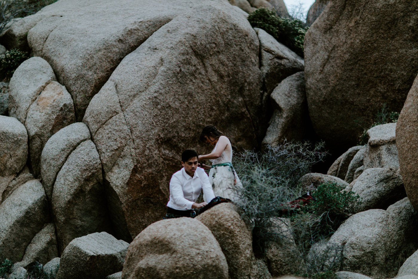 Shelby helps Zack put on his mountain climbing gear in Joshua Tree.