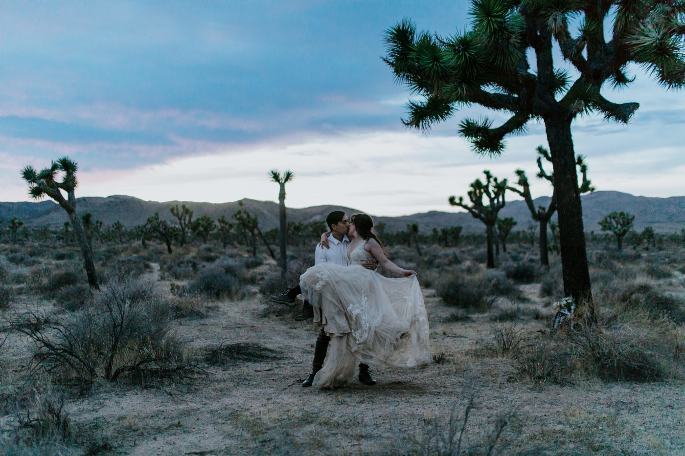 Zack holds Shelby as they stand in Joshua Tree National Park.