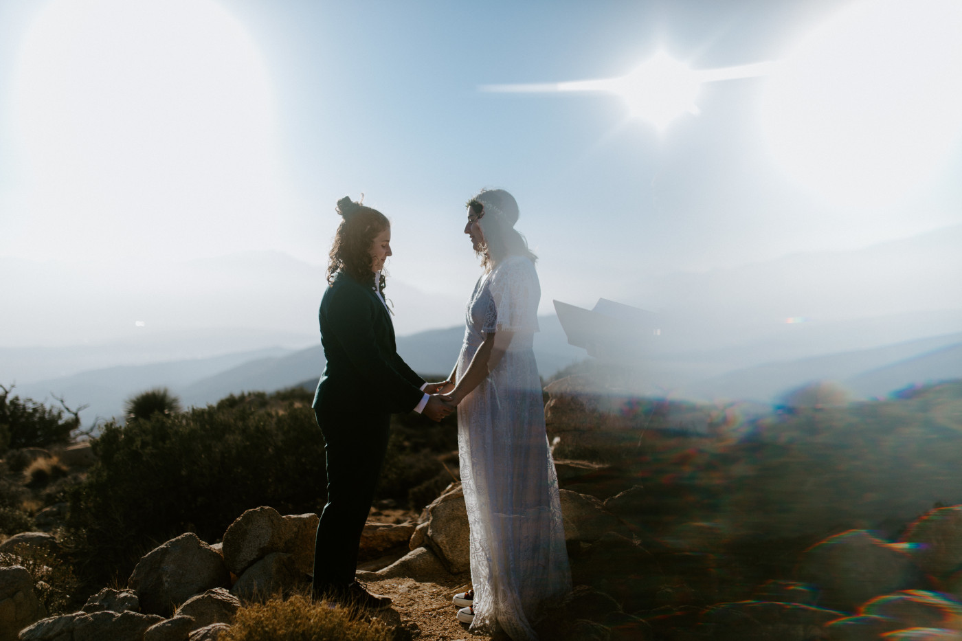 Becca and Madison hold hands in the Joshua Tree desert.