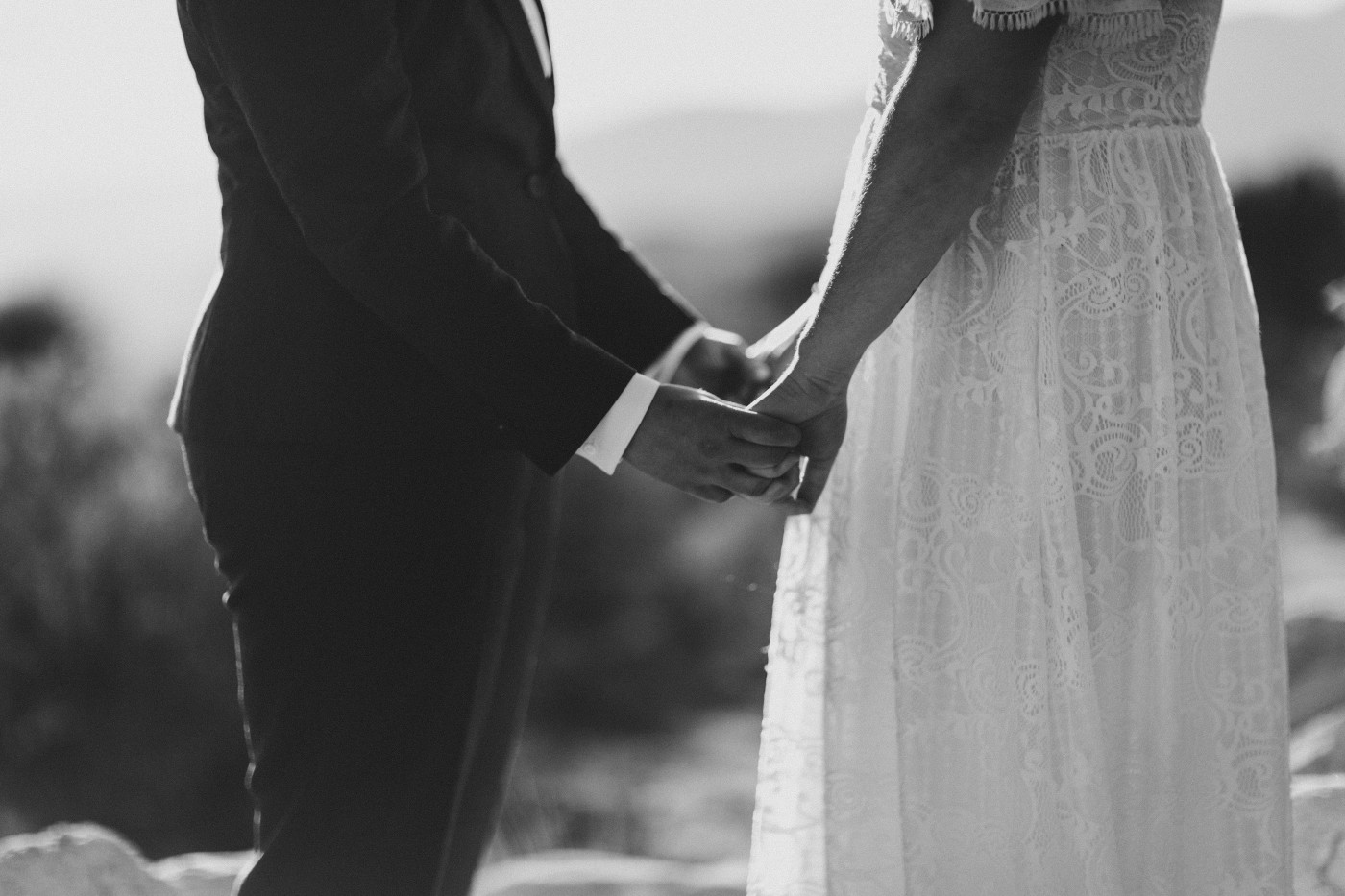 Becca and Madison hold hands in the Joshua Tree National Park during their elopement.