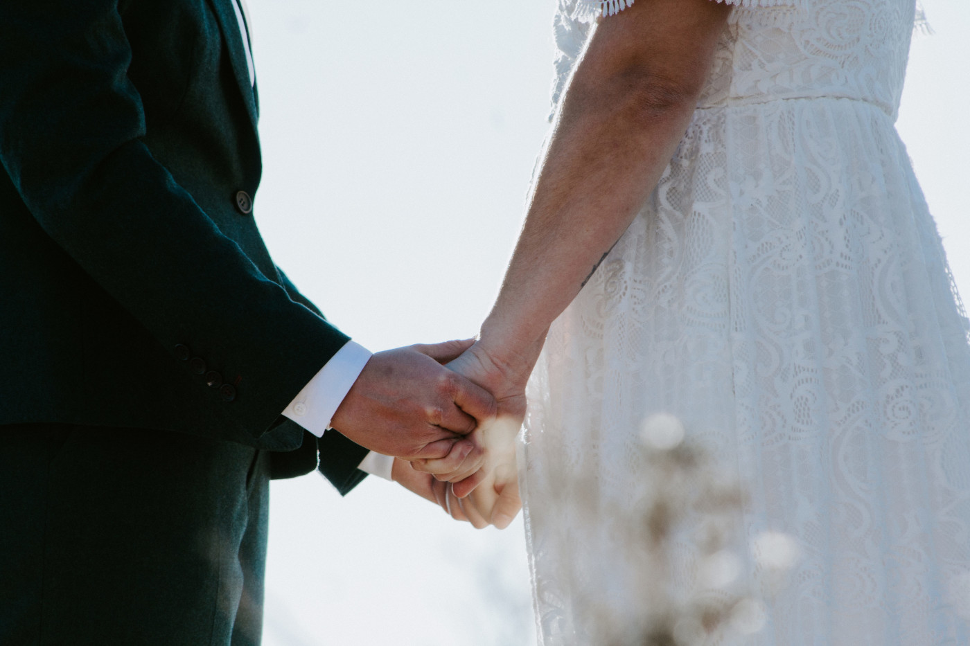 Becca and Madison hold hands at their elopement.