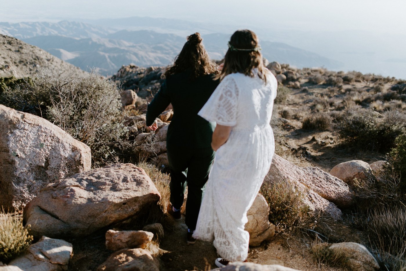 Becca and Madison walk through the rocky desert.