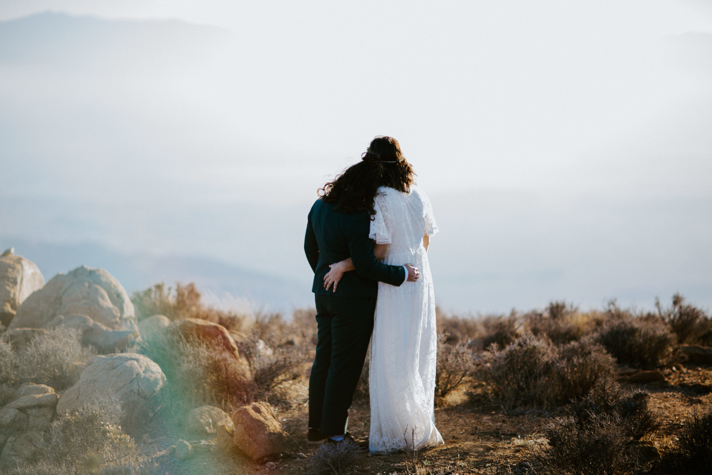 Becca and Madison hold each other in the desert.