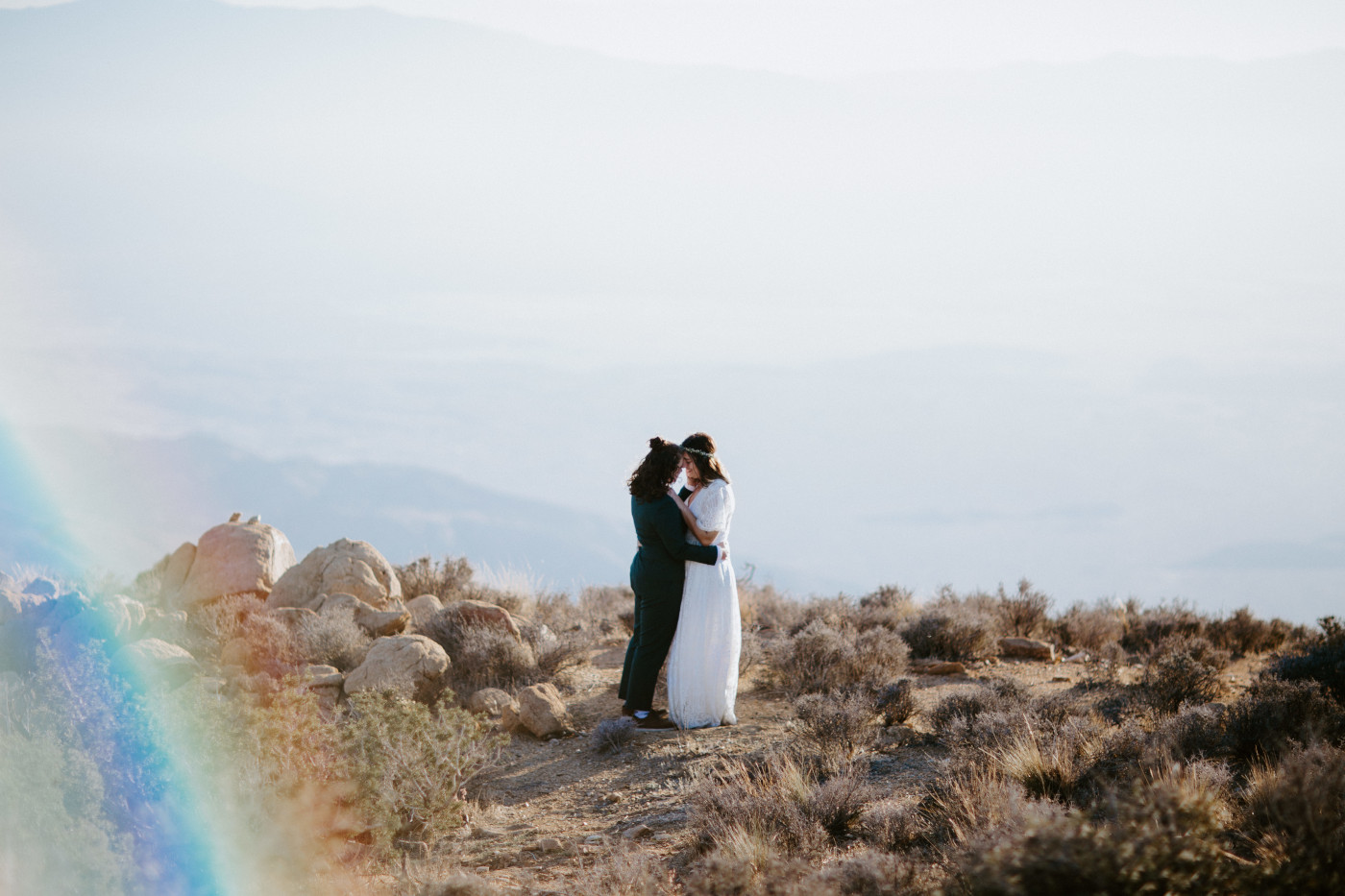 Becca and Madison hold each other in the desert.