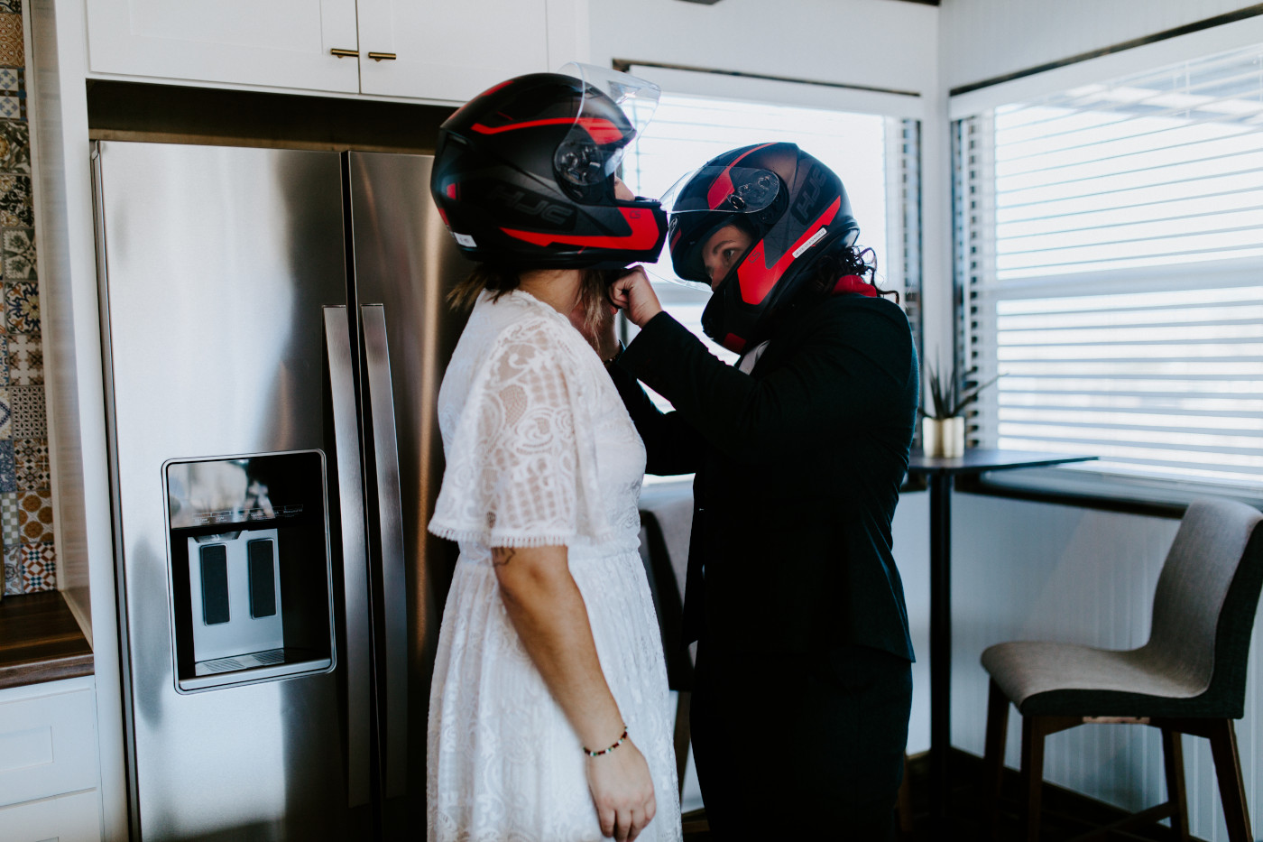 Madison and Becca put on motorcycle helmets.