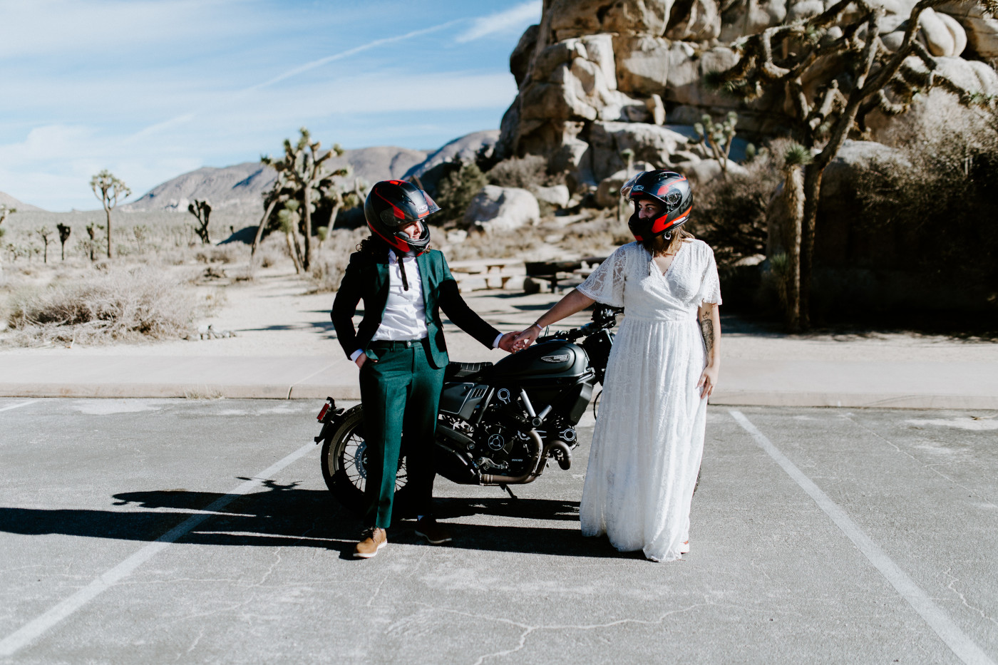 Becca and Madison stand near their motorcycle.