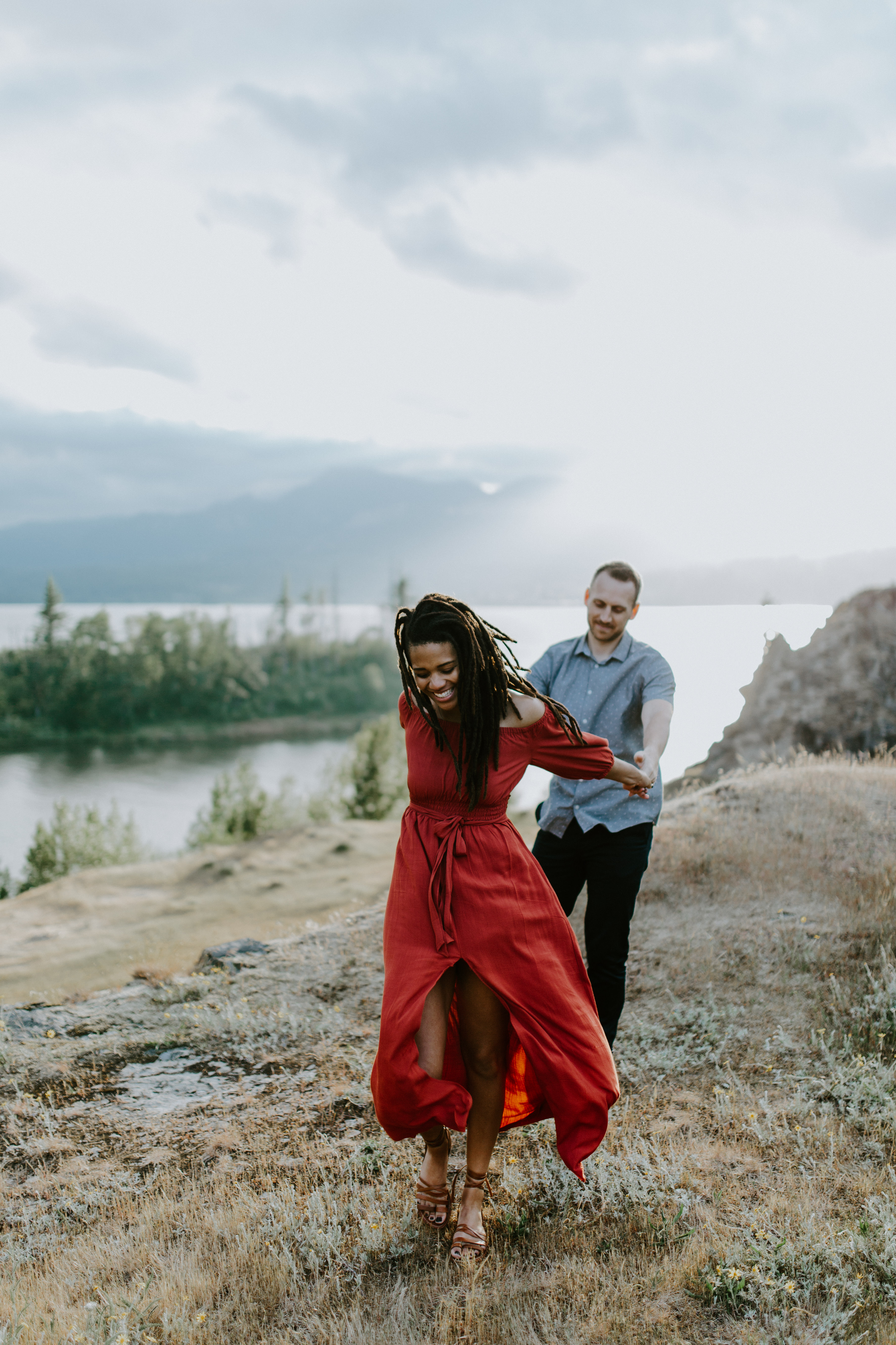 Kayloni and Garrett stand in front of the Columbia River Gorge, Oregon. Engagement photography in Portland Oregon by Sienna Plus Josh.