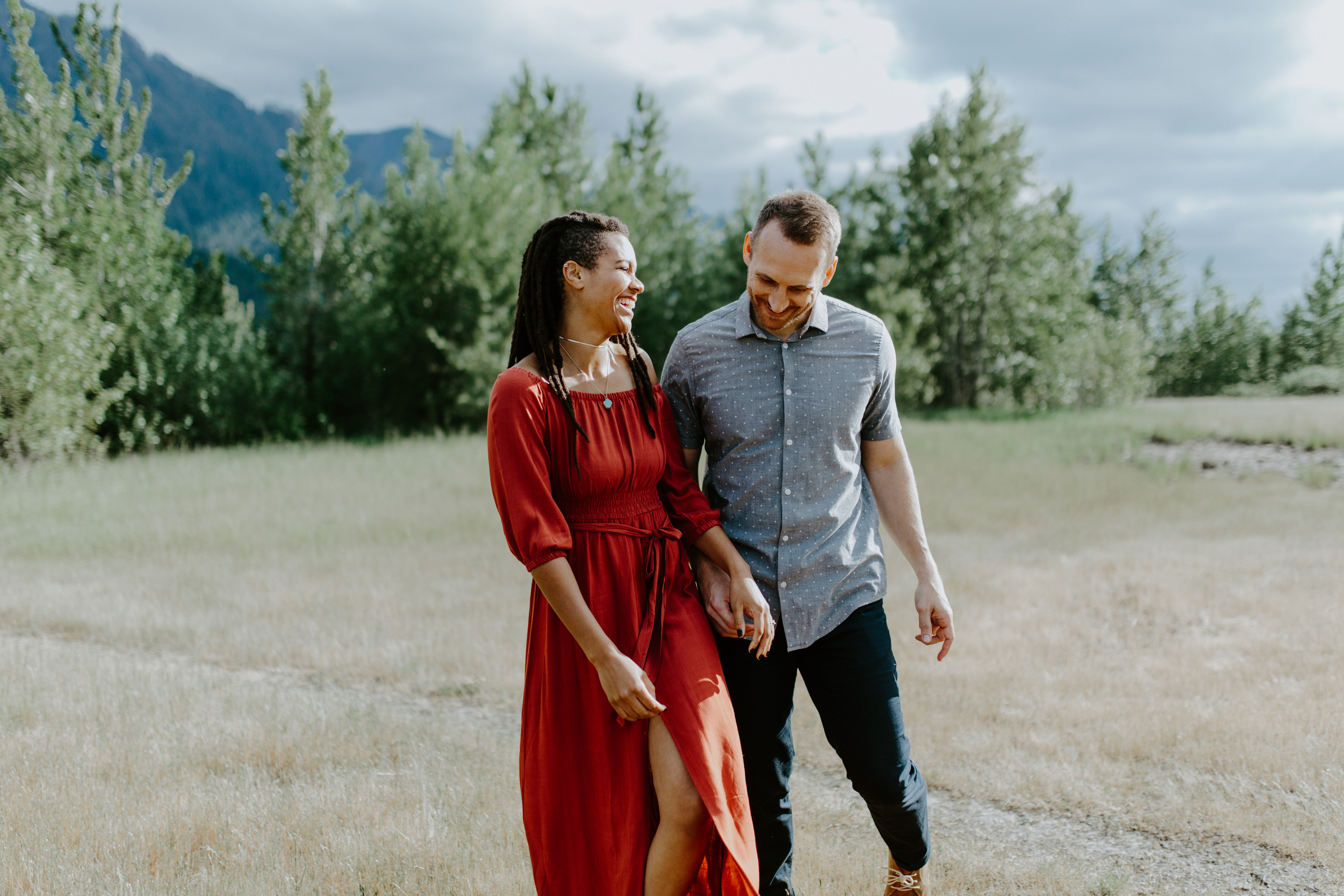 Kayloni and Garrett walk along the grass at Cascade Locks, Oregon. Engagement photography in Portland Oregon by Sienna Plus Josh.