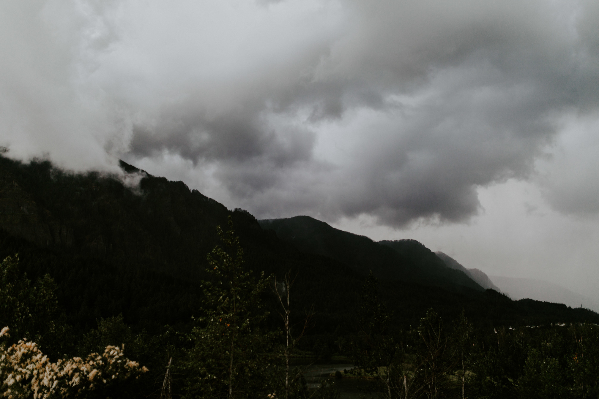 A view of the clouds and mountains of the Columbia River Gorge. Elopement wedding photography at Cascade Locks by Sienna Plus Josh.