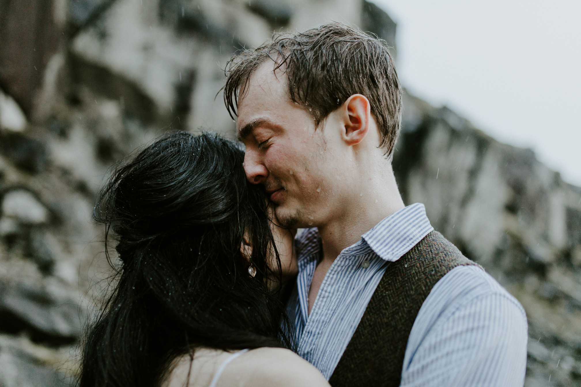 Kimberlie and Jacob hug in the rain. Elopement wedding photography at Cascade Locks by Sienna Plus Josh.