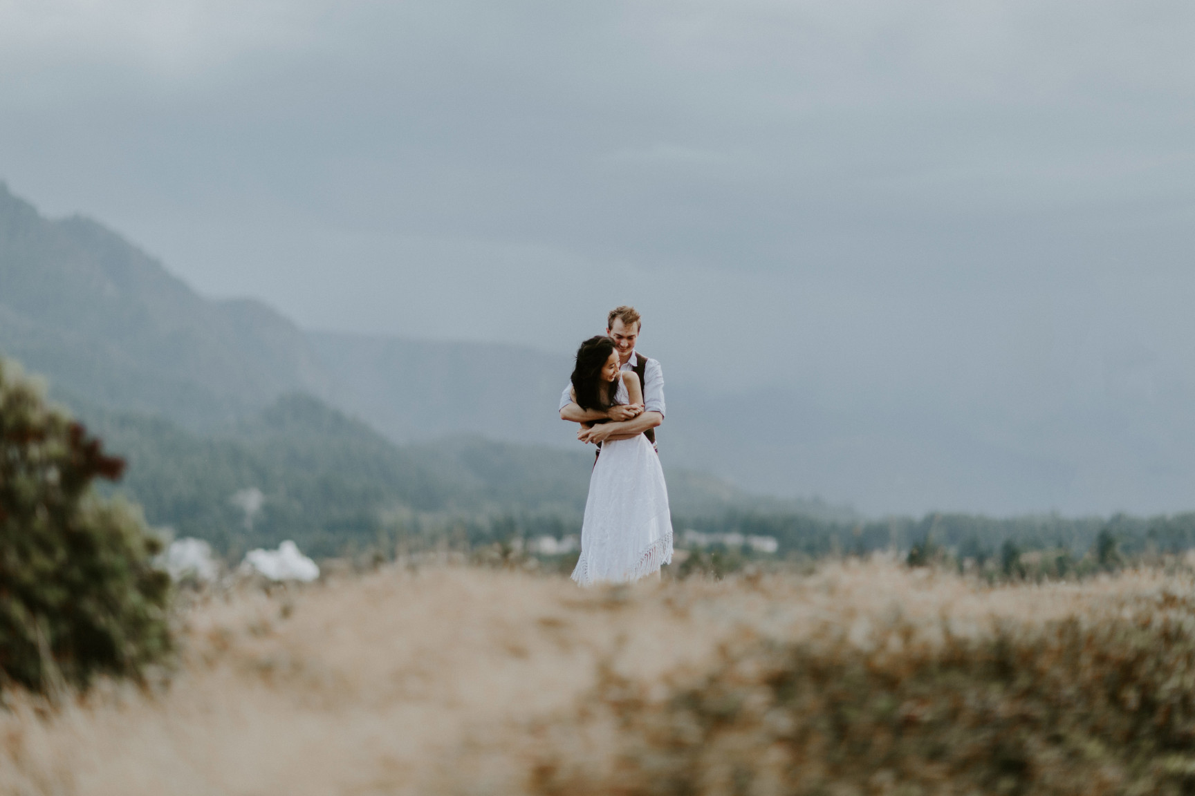 Jacob holds Kimberlie. Elopement wedding photography at Cascade Locks by Sienna Plus Josh.