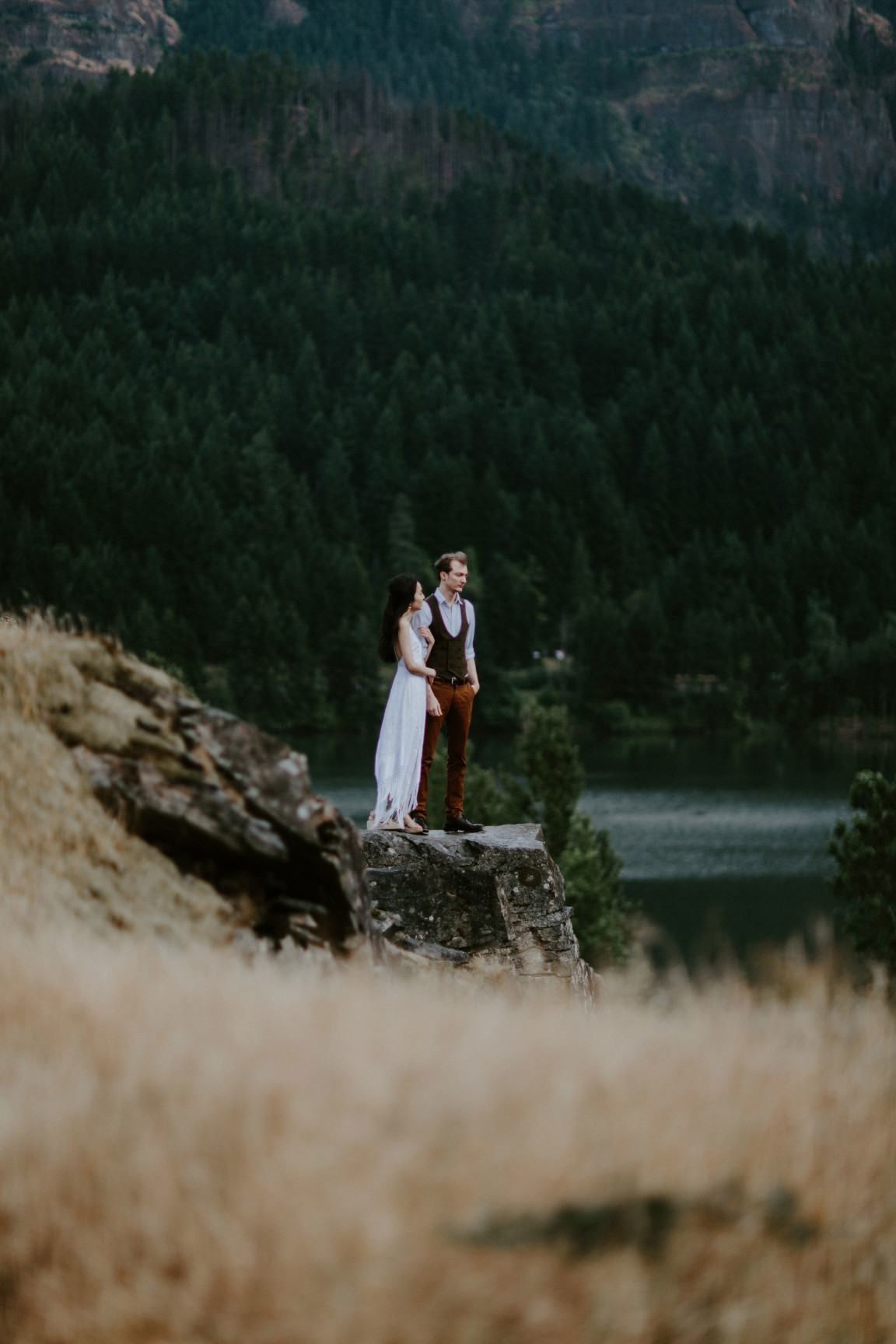 Kimberlie holds Jacob's arm. Elopement wedding photography at Cascade Locks by Sienna Plus Josh.