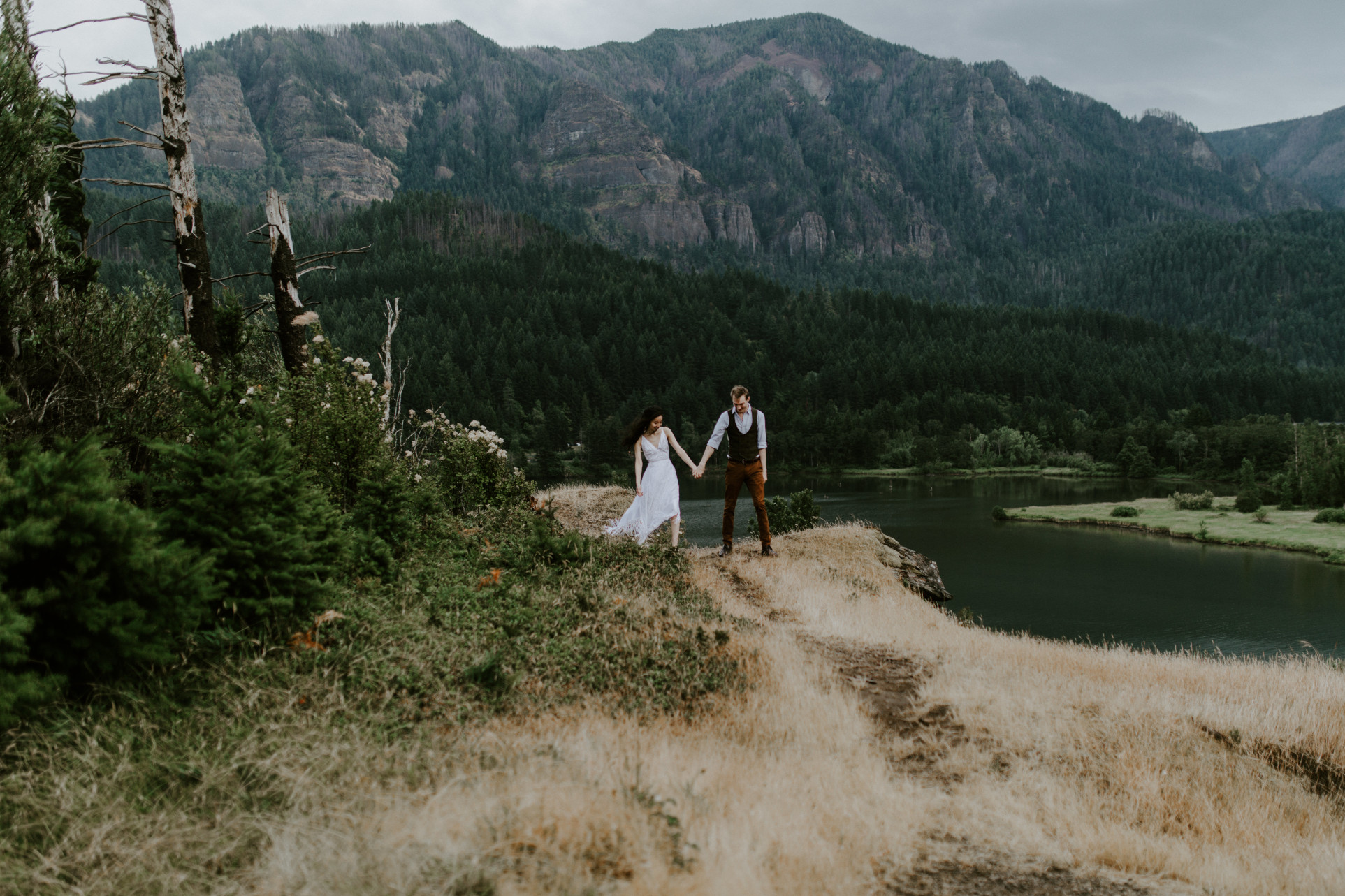 Jacob holds Kimberlie's hand. Elopement wedding photography at Cascade Locks by Sienna Plus Josh.