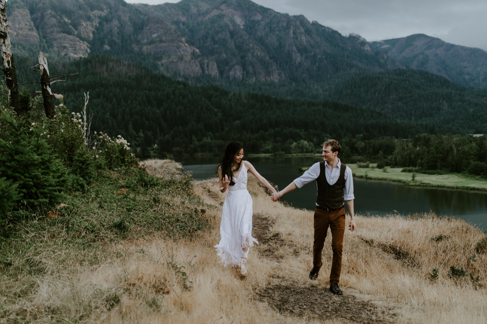 Kimberlie and Jacob walk through along the cliff of Cascade Locks. Elopement wedding photography at Cascade Locks by Sienna Plus Josh.