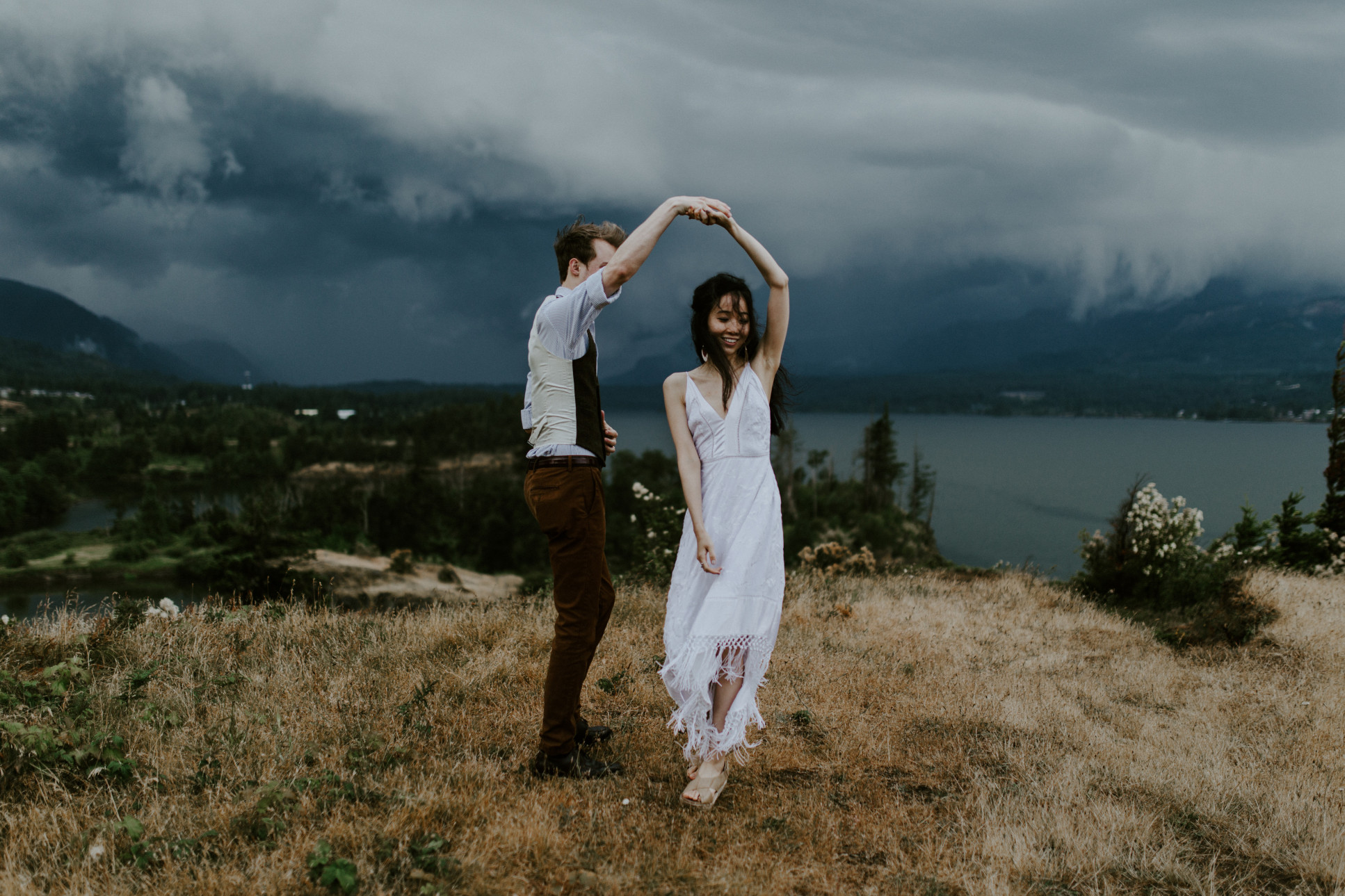 Jacob twirls Kimberlie as they dance. Elopement wedding photography at Cascade Locks by Sienna Plus Josh.