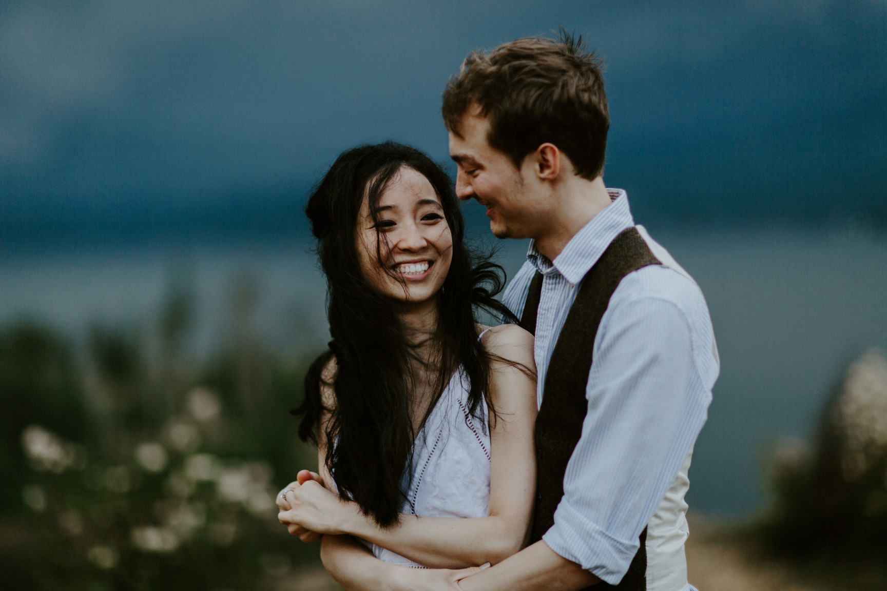 Kimberlie smiles as Jacob hugs her. Elopement wedding photography at Cascade Locks by Sienna Plus Josh.