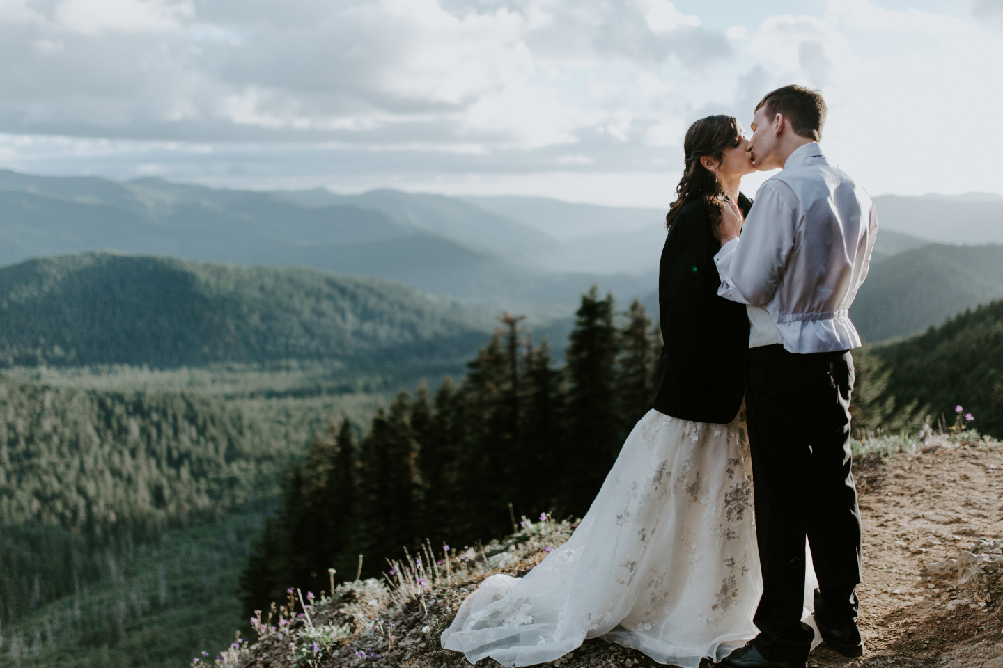 Ryan gives Moira his jacket near a view of the treeline near Mount Hood. Adventure elopement wedding shoot by Sienna Plus Josh.