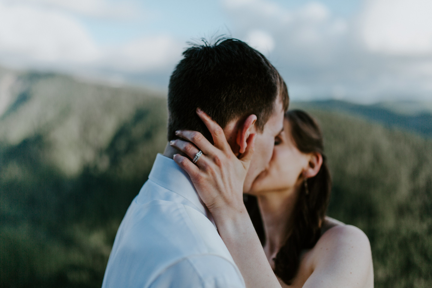 Moira and Ryan kiss in front of Mount Hood. Adventure elopement wedding shoot by Sienna Plus Josh.