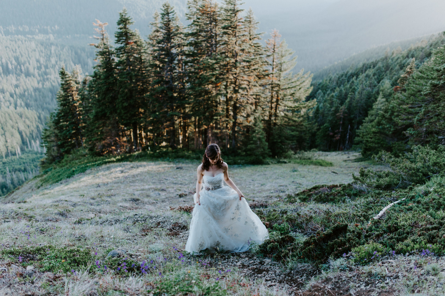 Moira walks up a slope on the trail near Mount Hood. Adventure elopement wedding shoot by Sienna Plus Josh.