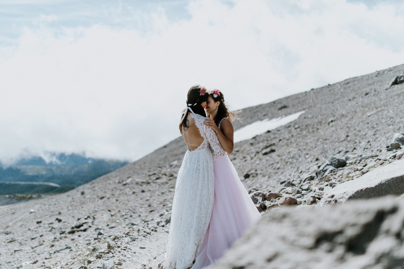 Margaux and Heather stand among the rocks of Mount Hood. Elopement photography at Mount Hood by Sienna Plus Josh.