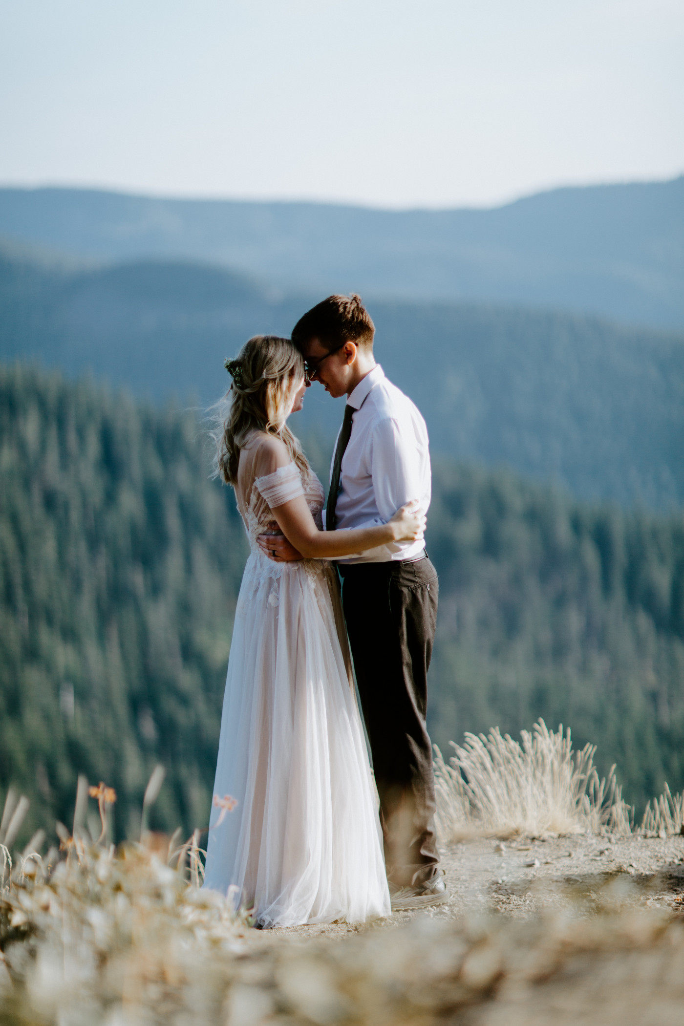 Corey and Kylie stand forehead to forehead in Mount Hood National Forest.