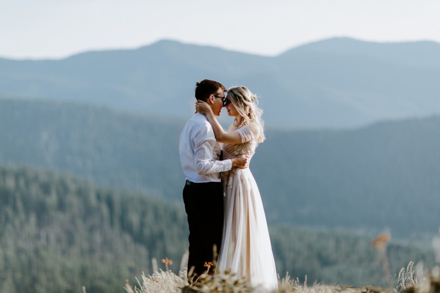 Corey and Kylie stand together near Mount Hood.