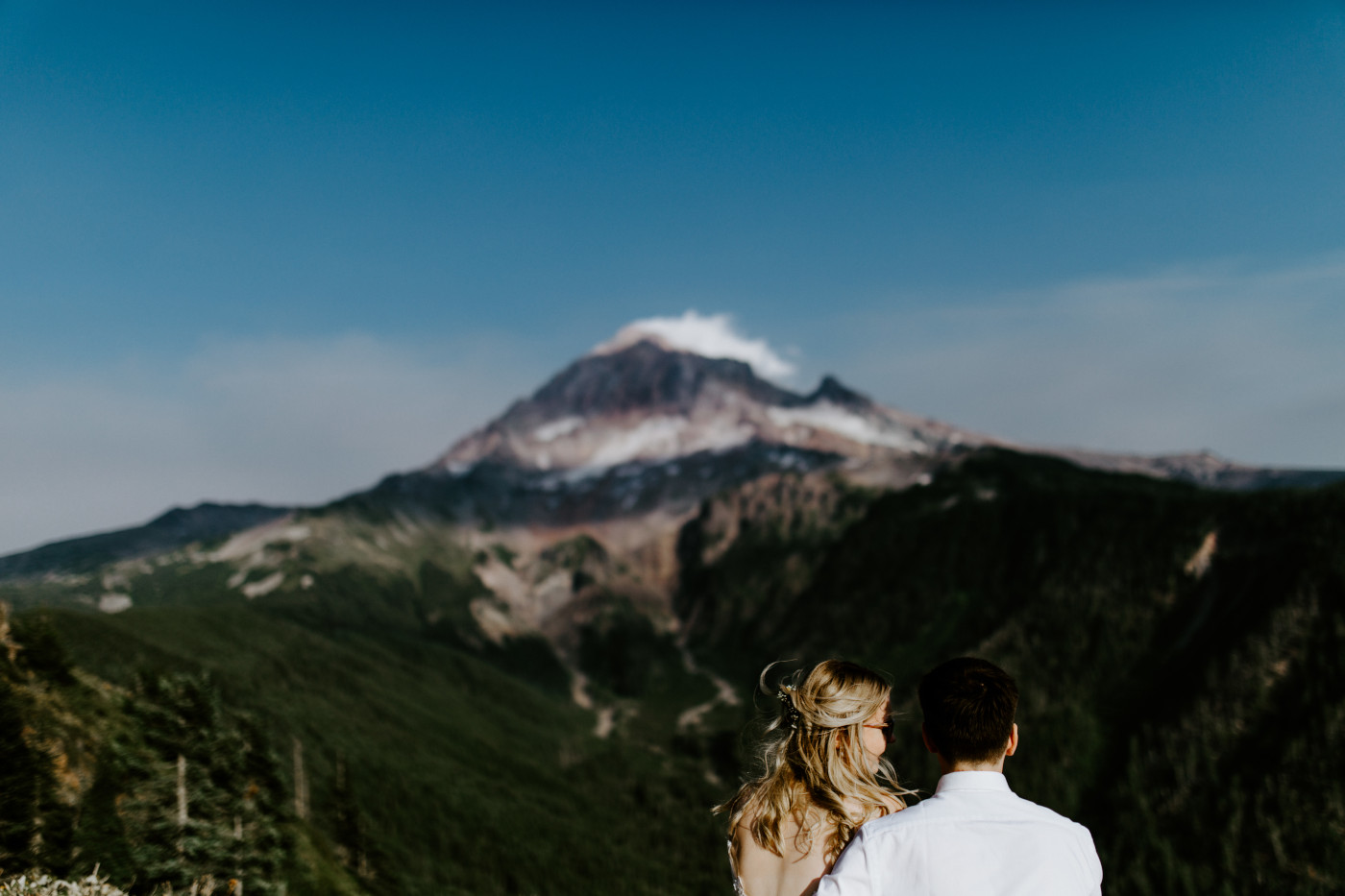 Kylie looks at Corey as he looks out at Mount Hood.