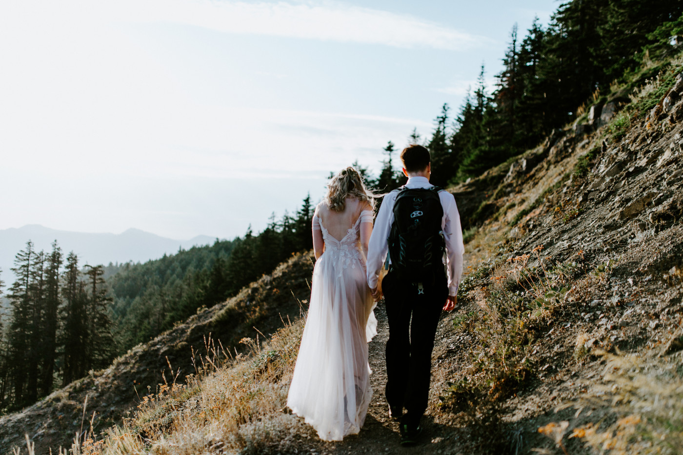 Kylie and Corey walk the trail near a cliff.